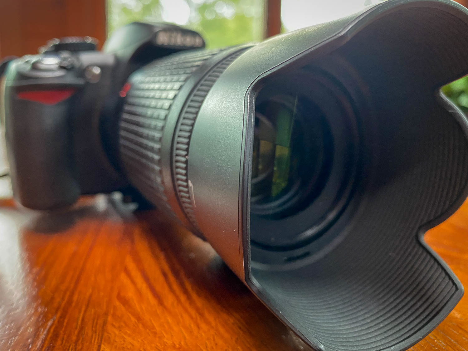 A close-up of a long telephoto lens on a DSLR camera