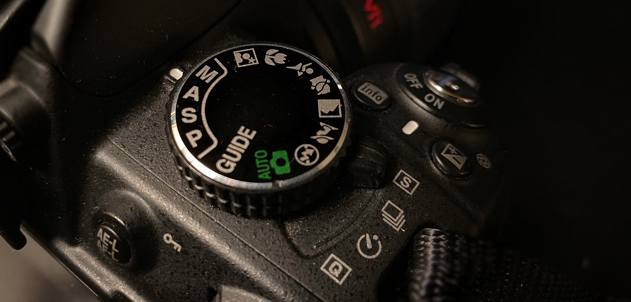 Close-up of a camera's mode dial