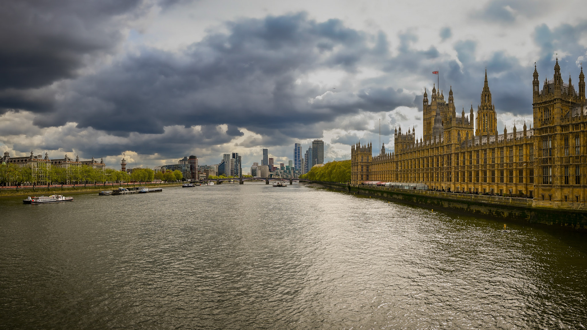 The River Thames in London, with dark clouds overhead.