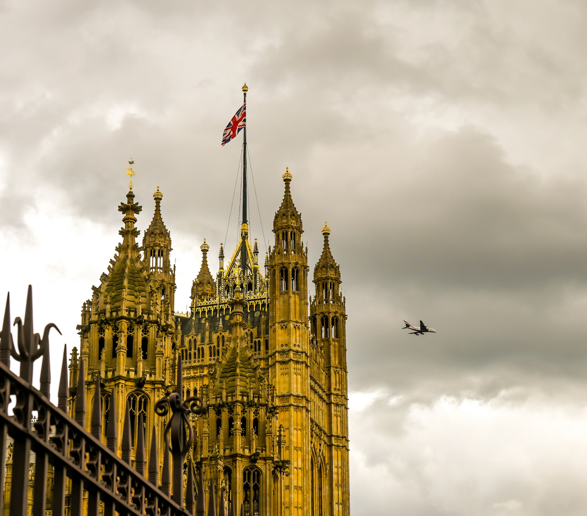 A jet flies over the Palace of Westminster, London.