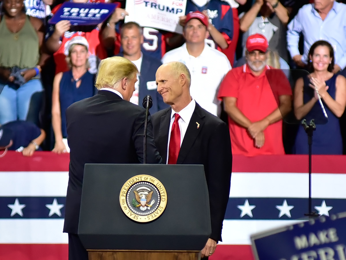 President Donald Trump speaks with Florida Governor Rick Scott, during a rally in Estero Florida, at a rally at Hertz Arena, in Estero Florida, on Wednesday, Oct 31, 2018.  Scott is running for U.S. Senate against Bill Nelson.