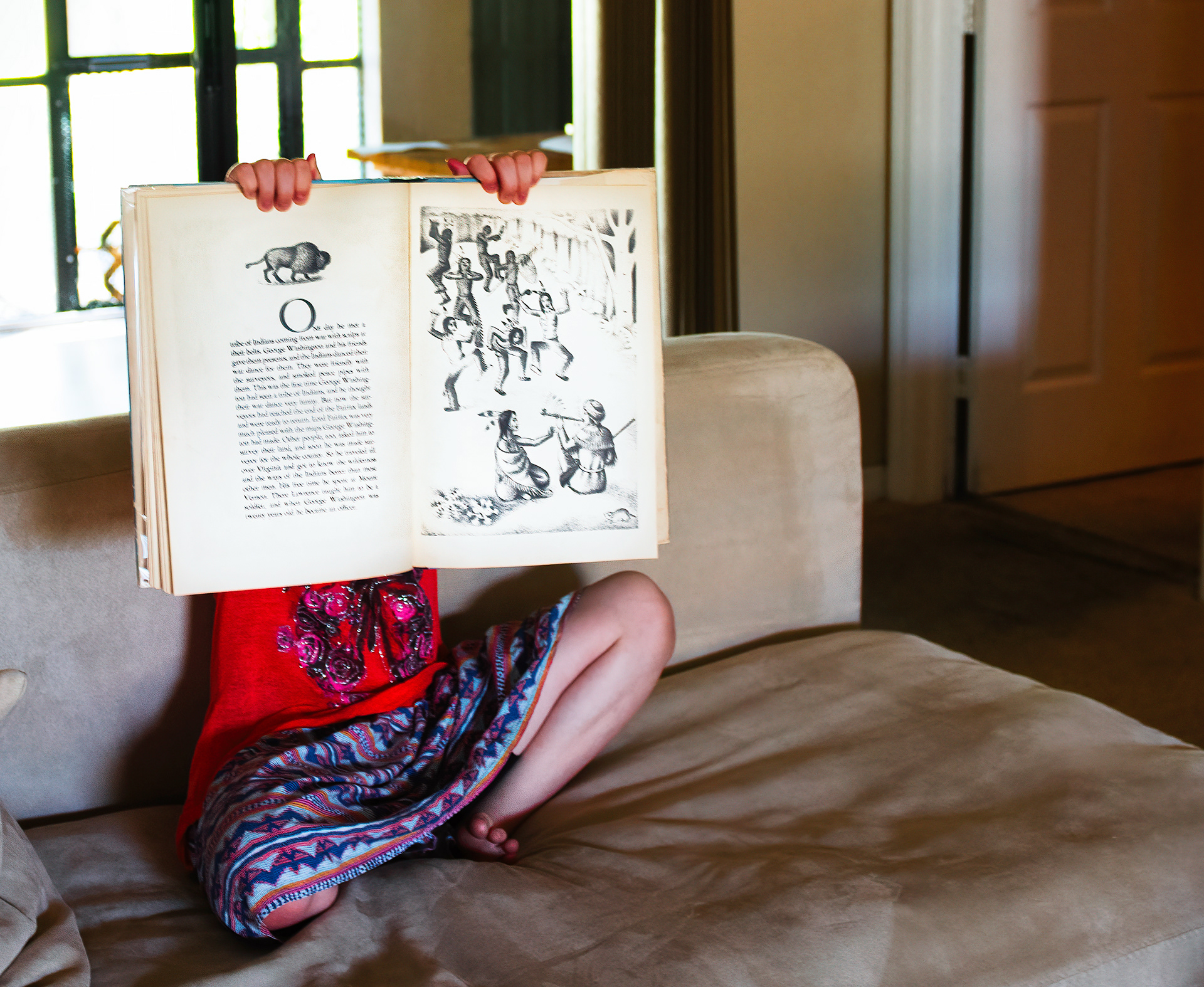 My daughter holds a book, while we are under lockdown