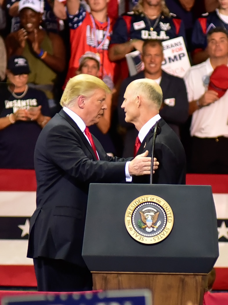 President Donald Trump speaks with Florida Governor Rick Scott, during a rally in Estero Florida, at a rally at Hertz Arena, in Estero Florida, on Wednesday, Oct 31, 2018.  Scott is running for U.S. Senate against Bill Nelson.