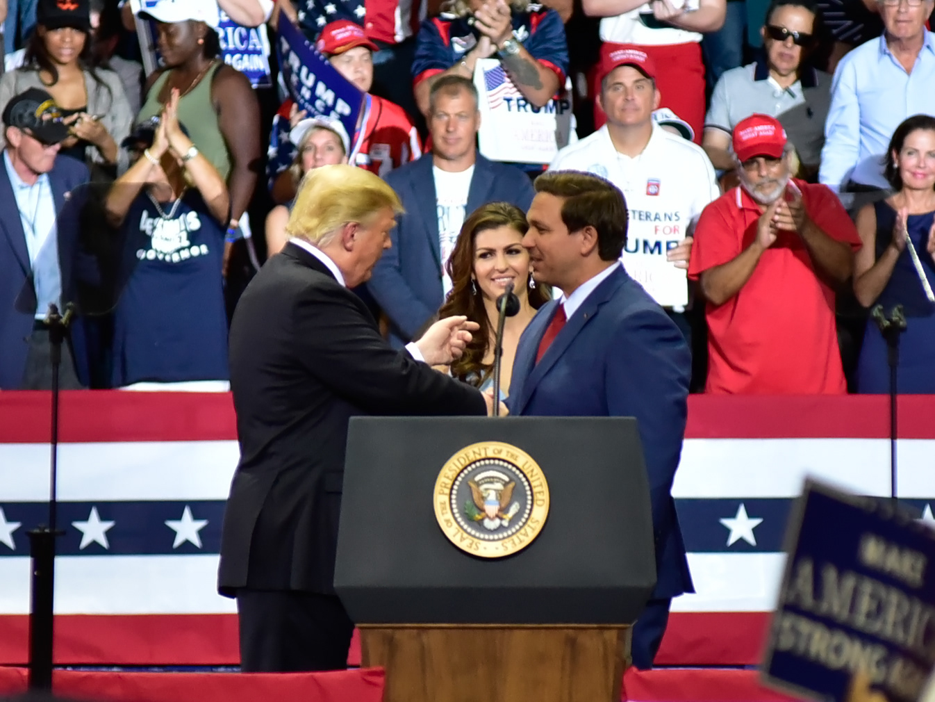 President Donald Trump speaks with Florida Gubernatorial Candidate Ron DeSantis at a rally in Estero Florida on Wednesday, Oct 31, 2018.