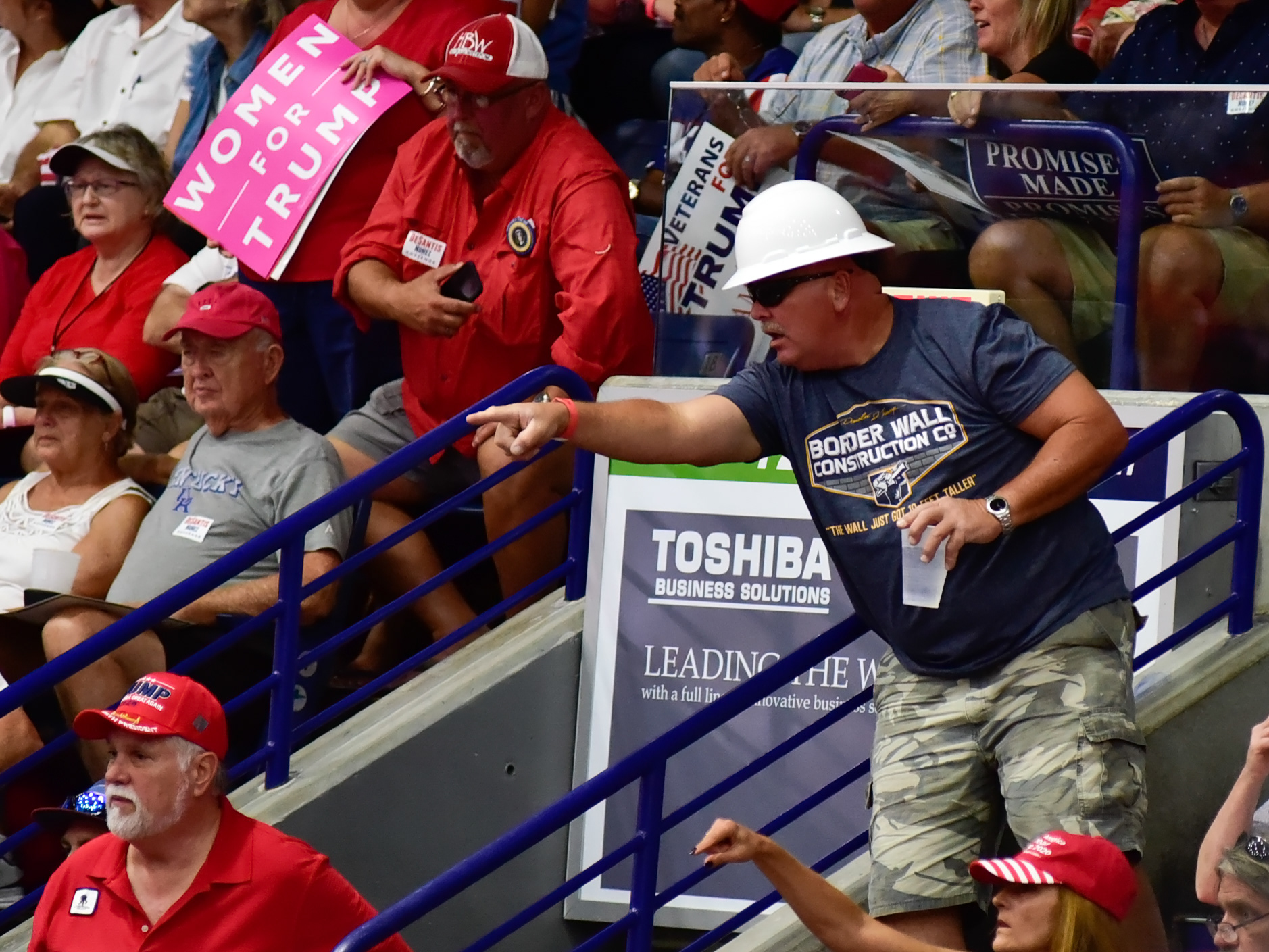 A man wearing a hard hat shouts "build the wall" at a Trump rally, on Wednesday, Oct. 31, 2018, in Estero, Fla.
