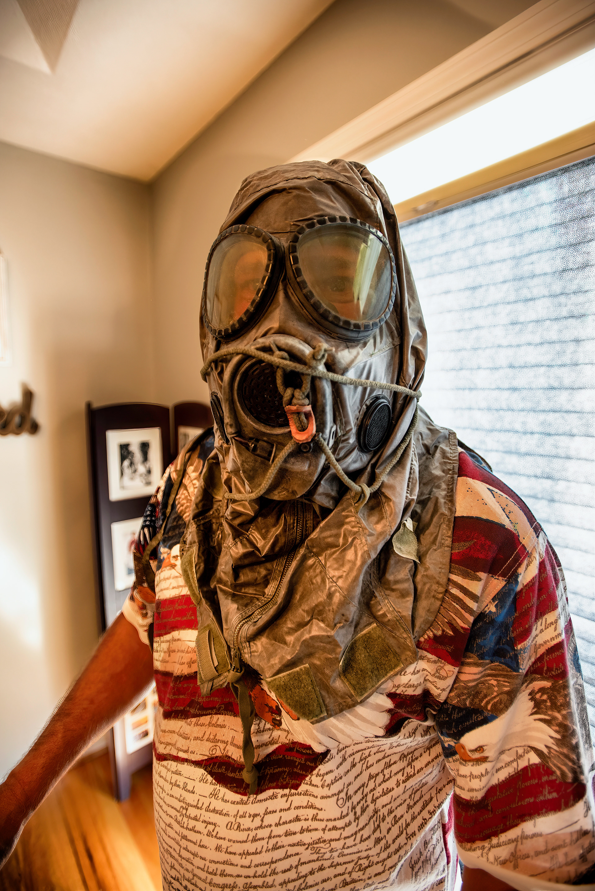 A war veteran dons a gas mask