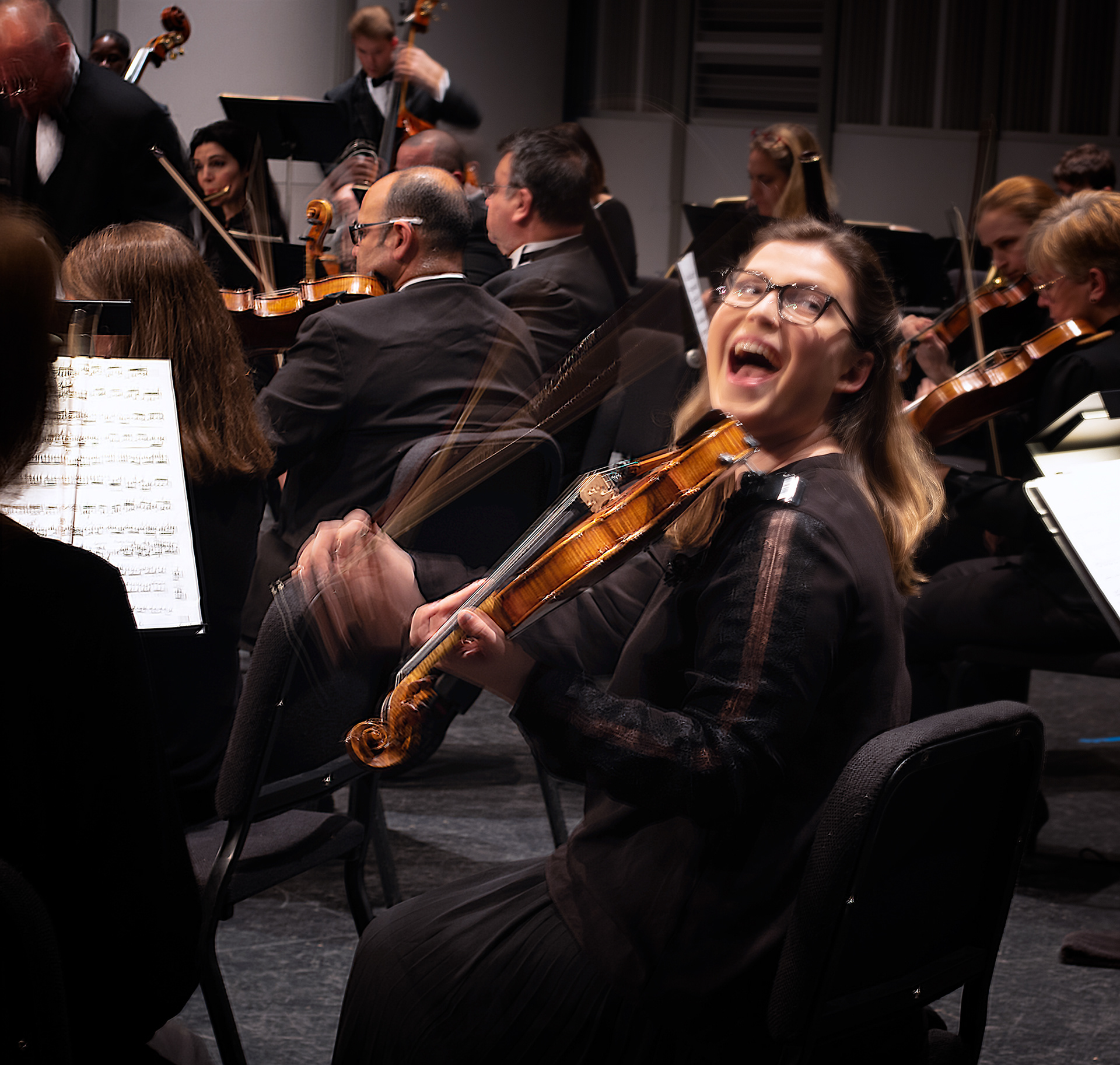 Charlotte Symphony Orchestra Violin II, Joy Chatzistamatis, greets a friend before a performance.