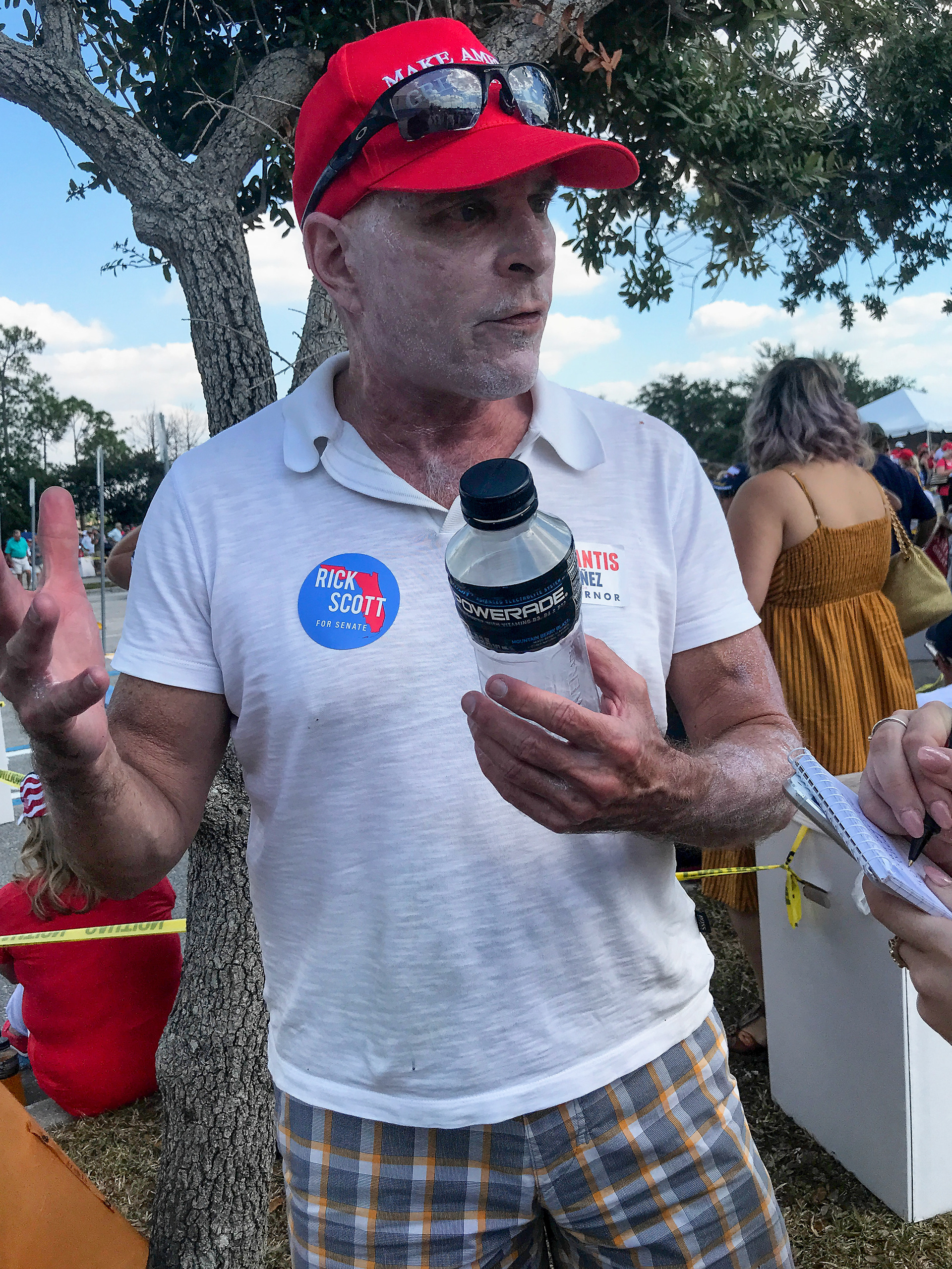 A man wearing sunscreen waits to enter Hertz Arena, before a Trump rally, on Wednesday, Oct 31, 2018, in Estero, Fla.