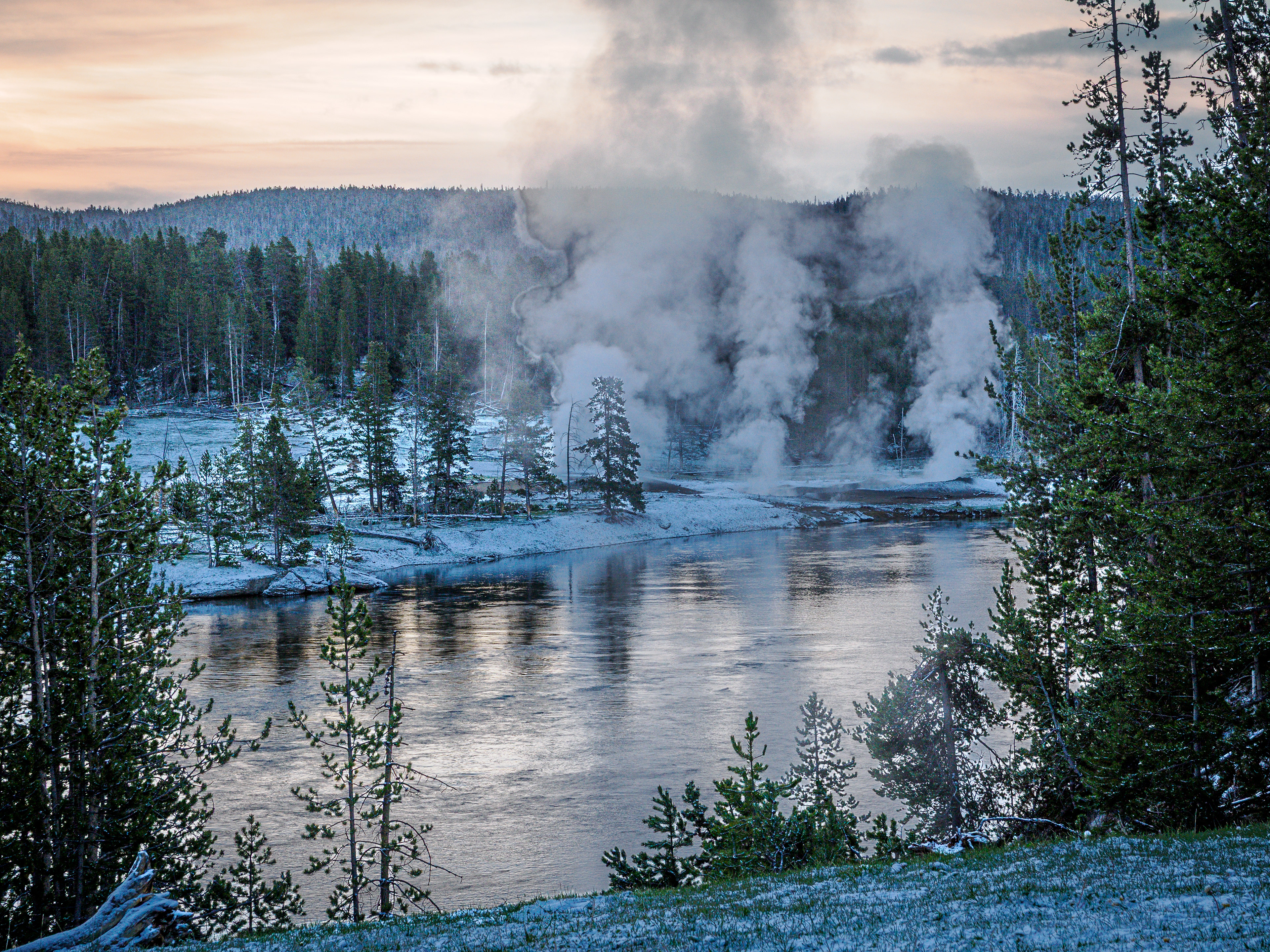 Yellowstone River at sunrise in southern Hayden Valley.  Thermal vents in the background.  After light overnight snow.  Yellowstone National Park.
