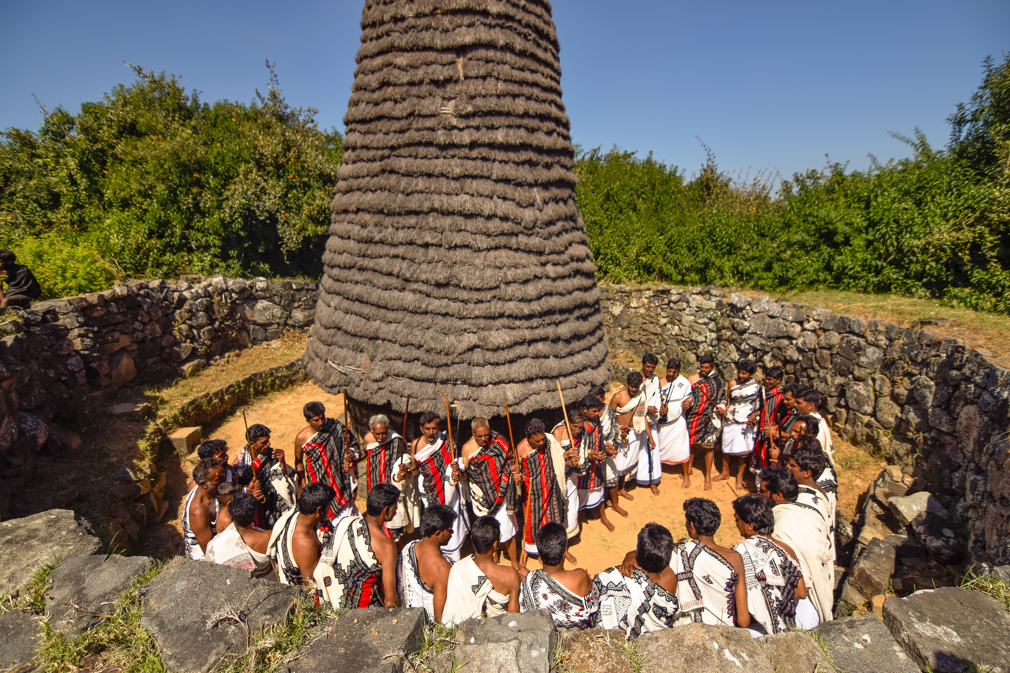 Toda men performing their ritual dance while chanting.