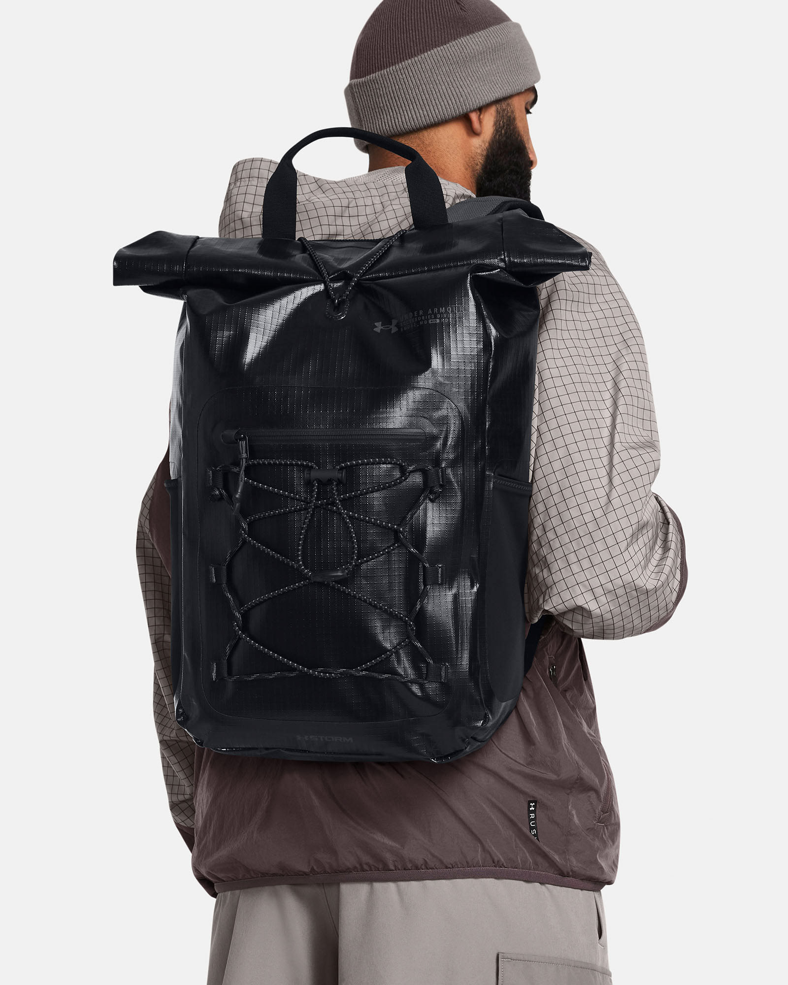 Muhammad Abbasi | Under Armour | Hats & Accessories | Black roll-top backpack, grey long sleeve shirt, taupe beanie