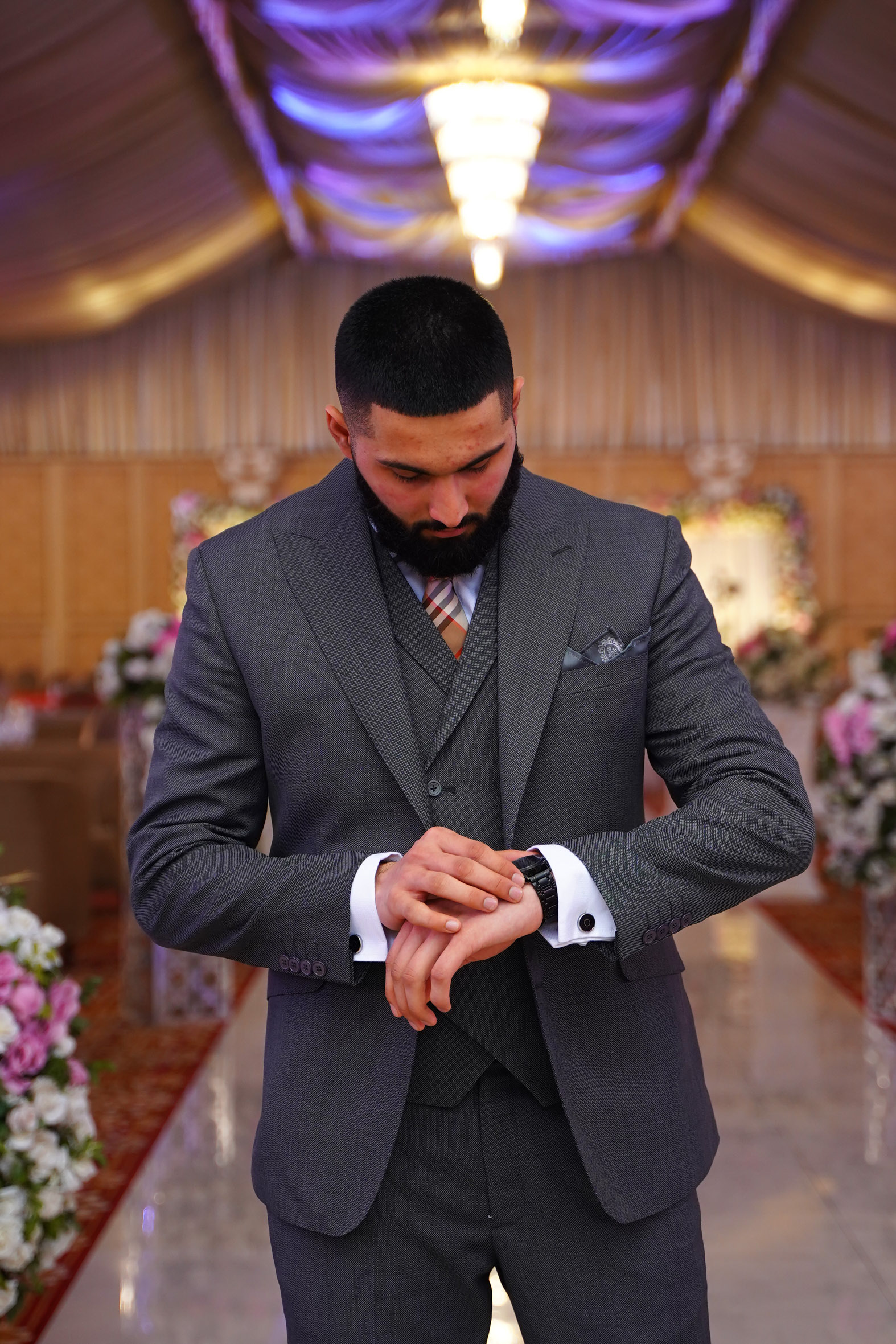 Muhammad Abbasi | Formal Wear | Charcoal three-piece suit with striped tie, checking watch