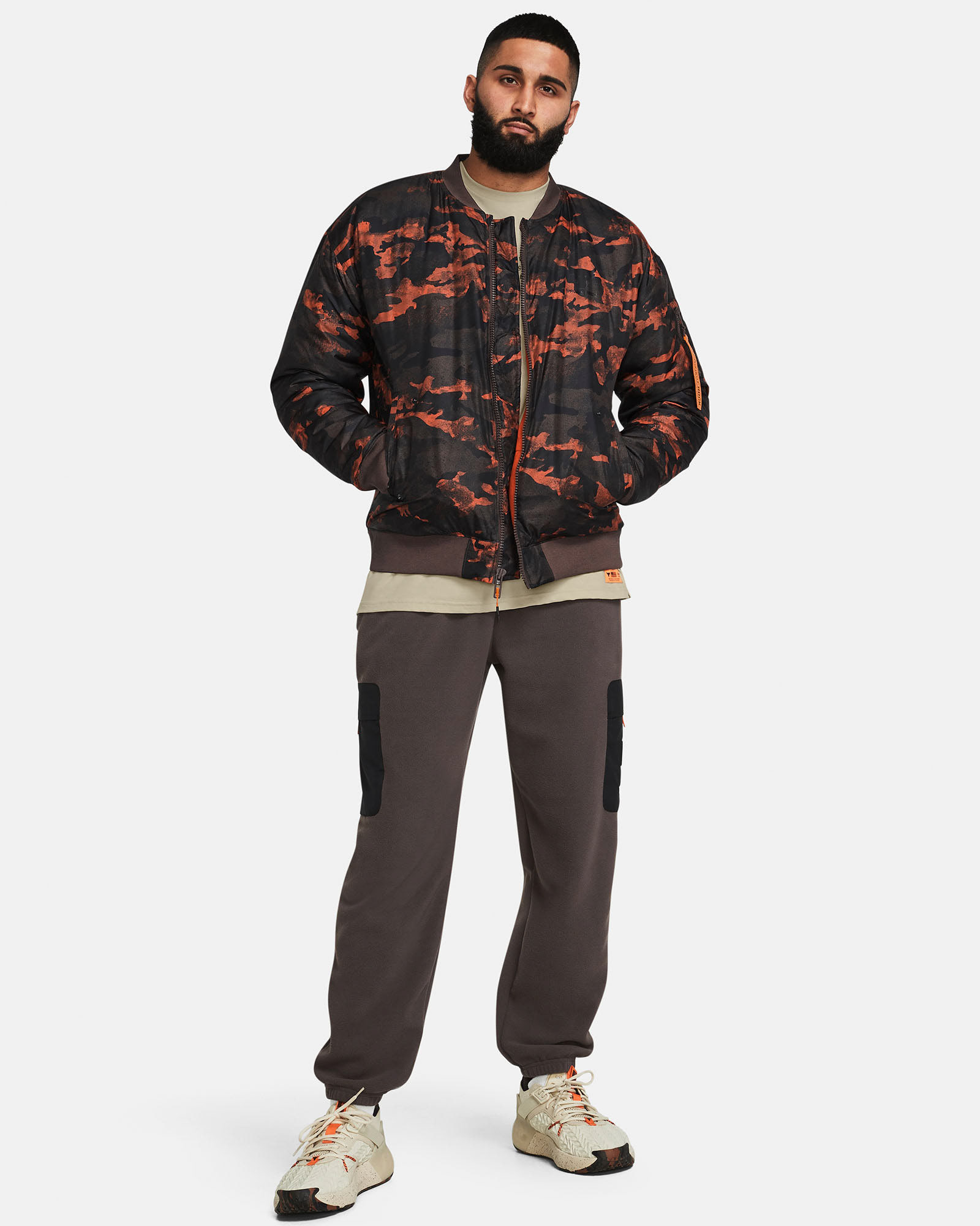 Muhammad Abbasi | Under Armour | Ecom Shoot | Red and black camo Project Rock jacket with brown joggers