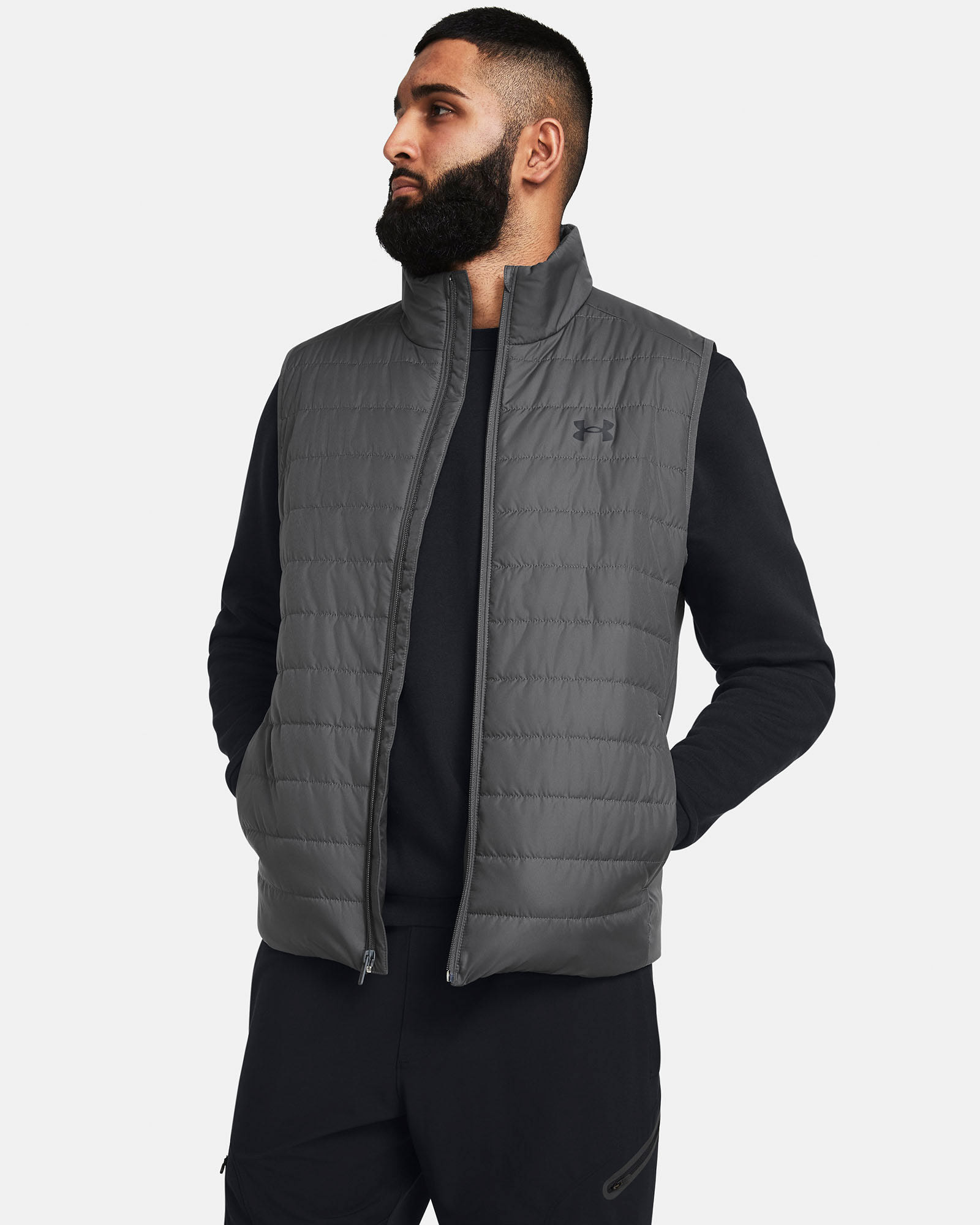 Muhammad Abbasi | Under Armour | Ecom Shoot | Grey quilted vest with black long-sleeve top