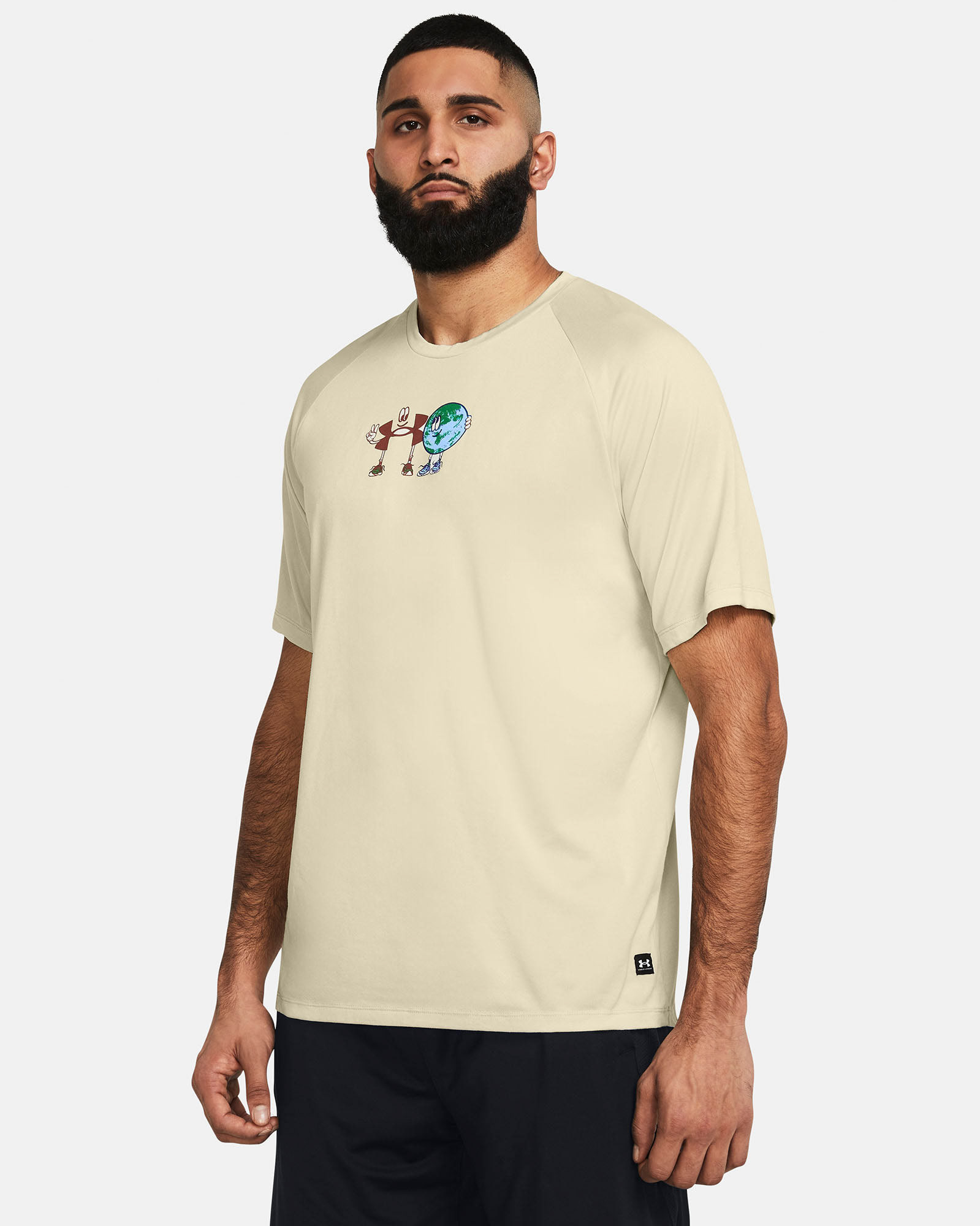 Muhammad Abbasi | Under Armour | Ecom Shoot | Beige short-sleeve graphic tee with black shorts