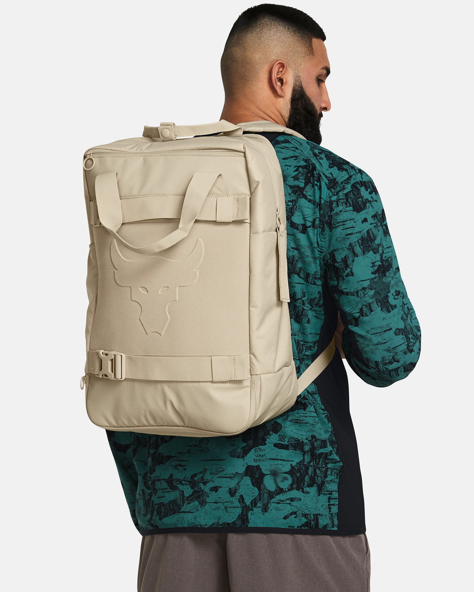 Muhammad Abbasi | Under Armour | Hats & Accessories | Beige backpack, green patterned long sleeve jacket