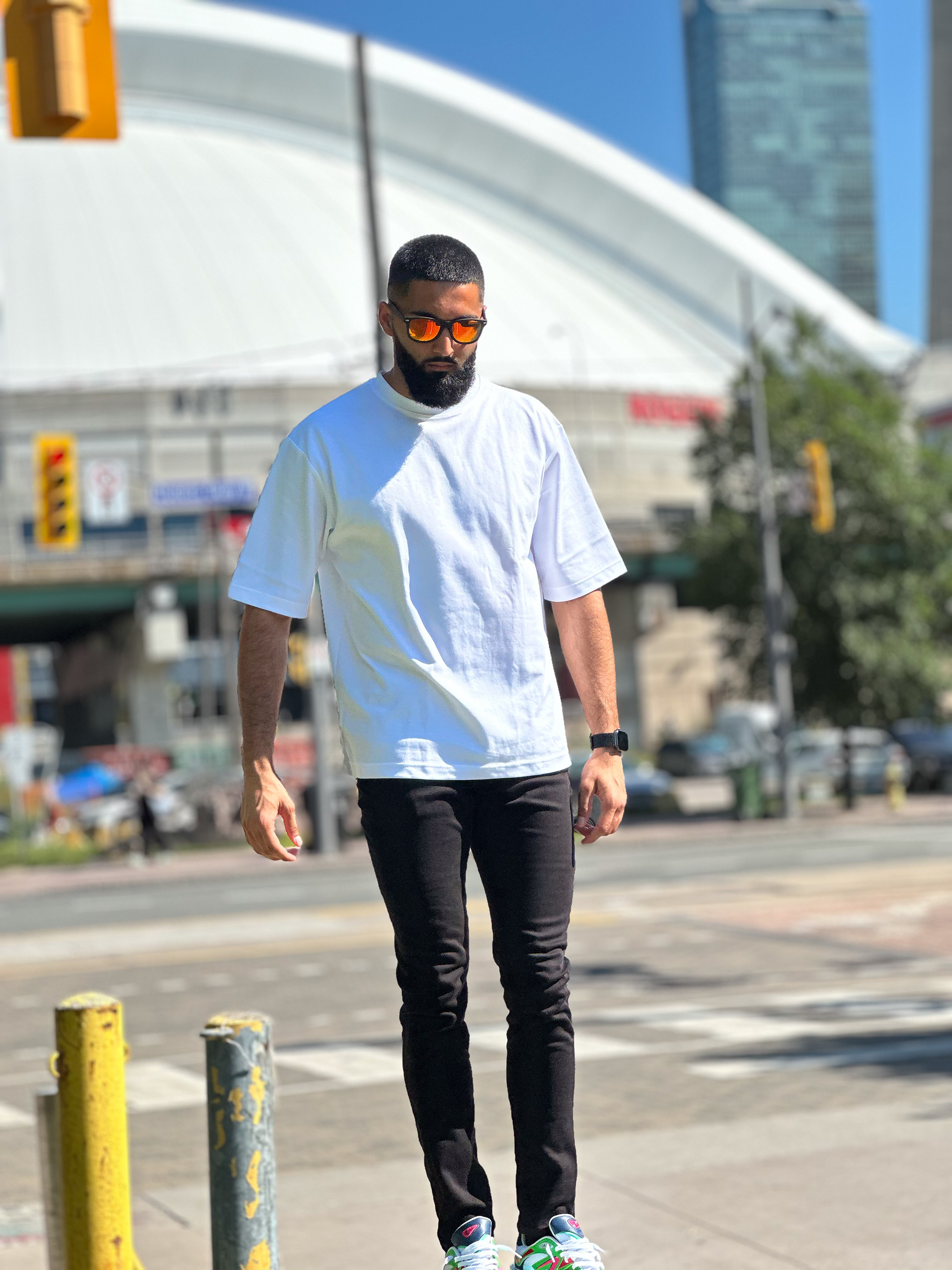 Muhammad Abbasi | Lifestyle | White oversized t-shirt, black jeans, colorful sneakers, walking in downtown Toronto