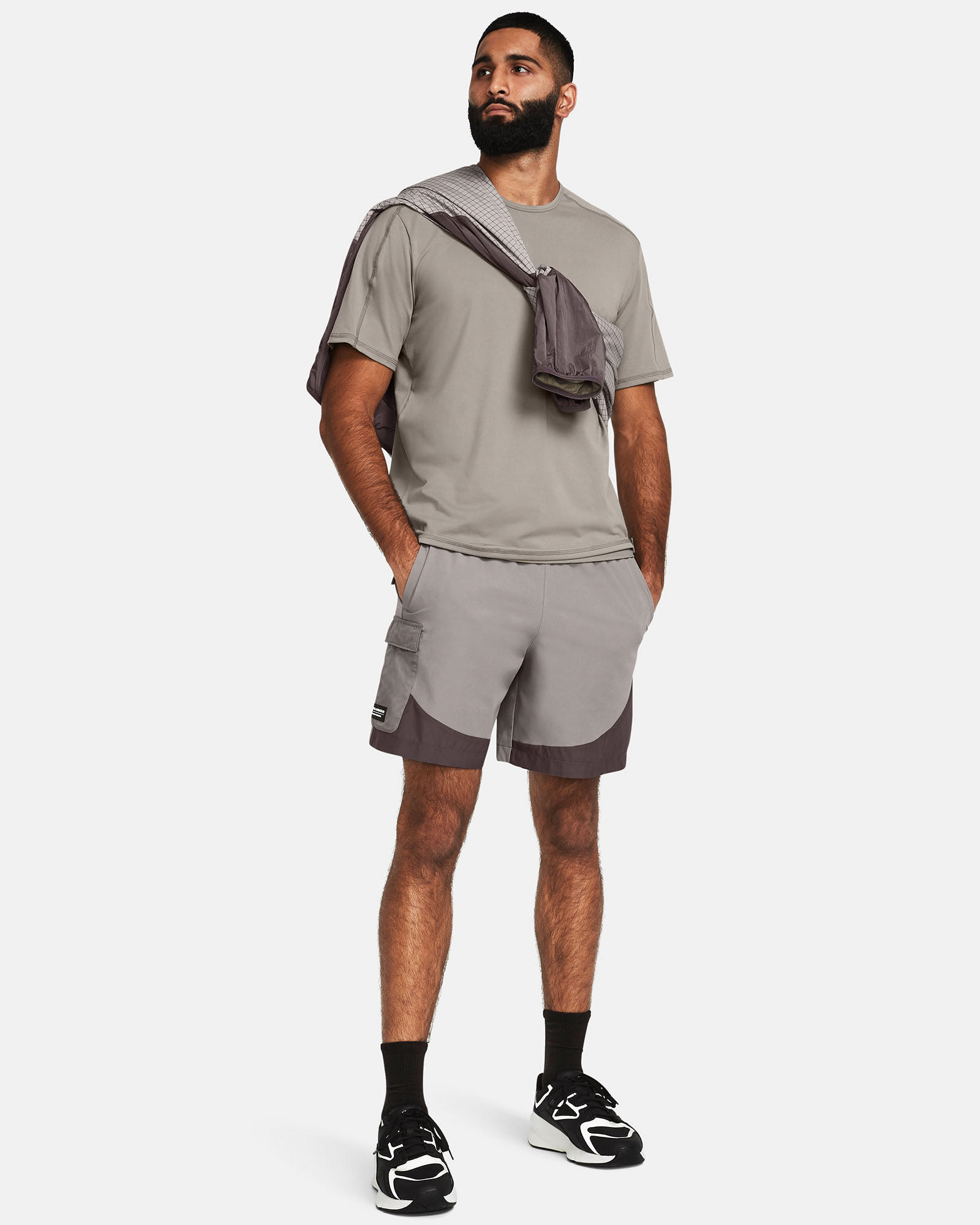 Muhammad Abbasi | Under Armour | Ecom Shoot | Light grey training set with sweatshirt draped over shoulders