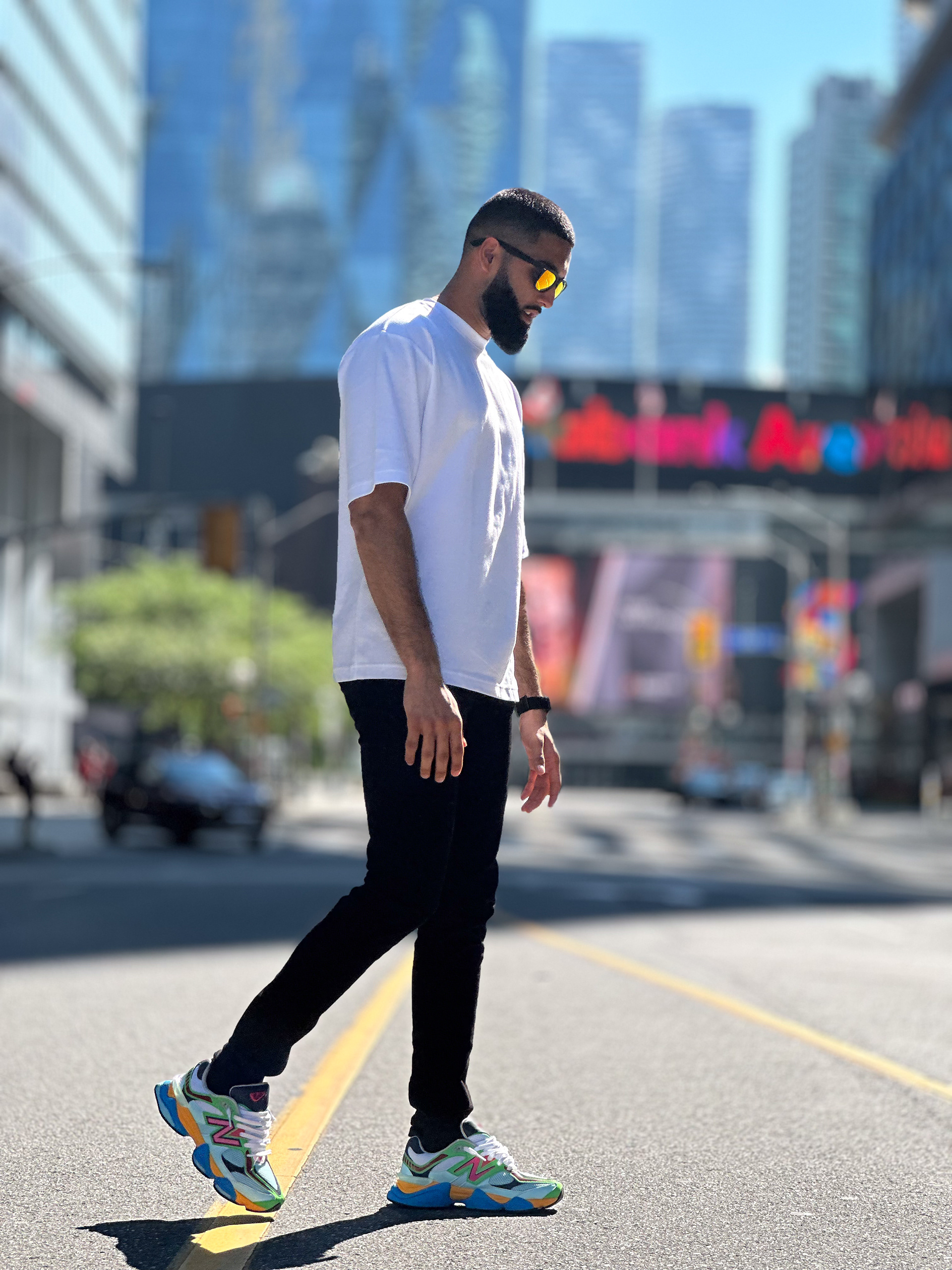 Muhammad Abbasi | Lifestyle | White oversized t-shirt, black jeans, colorful sneakers, close-up walking in Toronto street