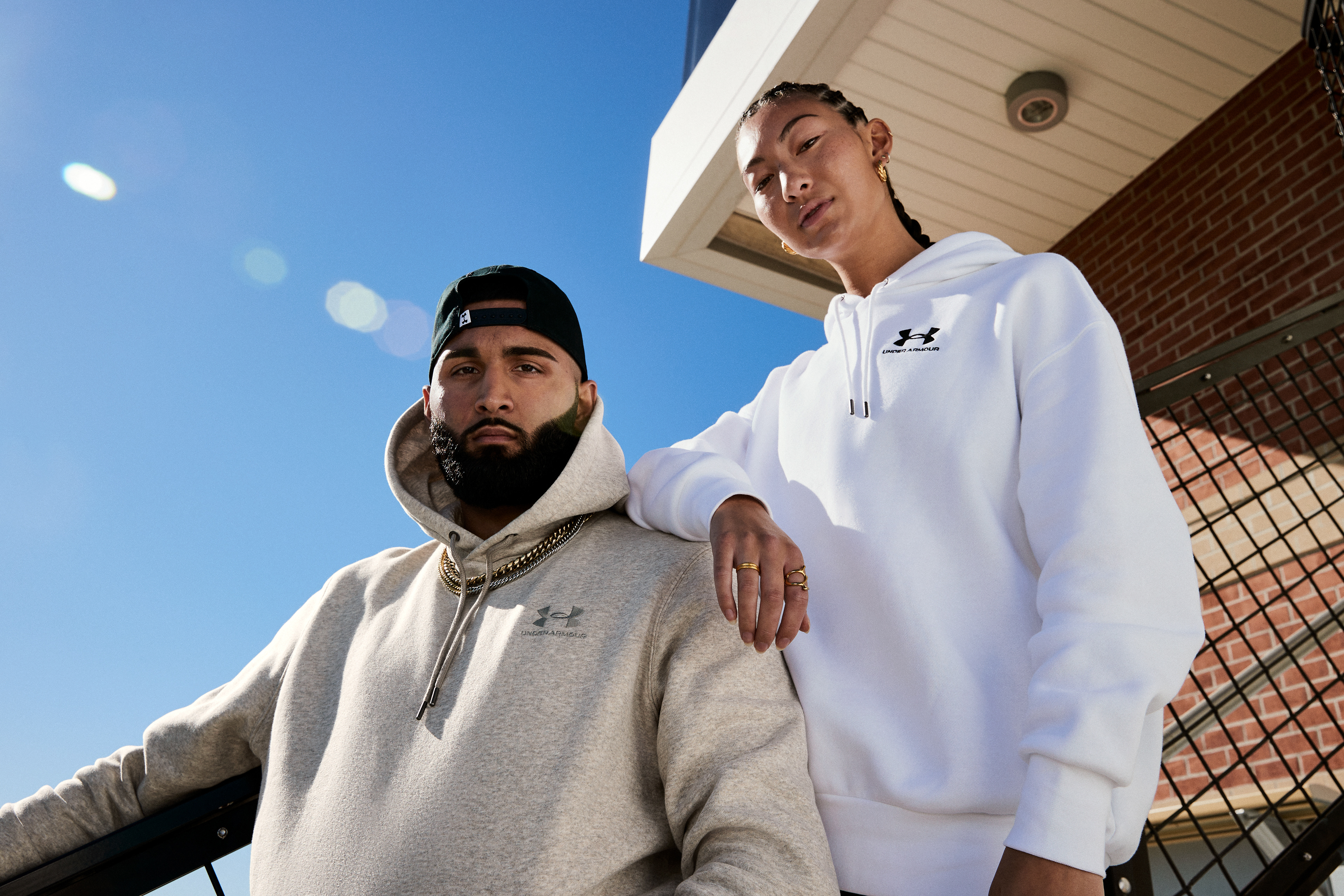 Muhammad Abbasi | Under Armour | ICON Fleece Hoodie | With Model Posing on Stadium Steps