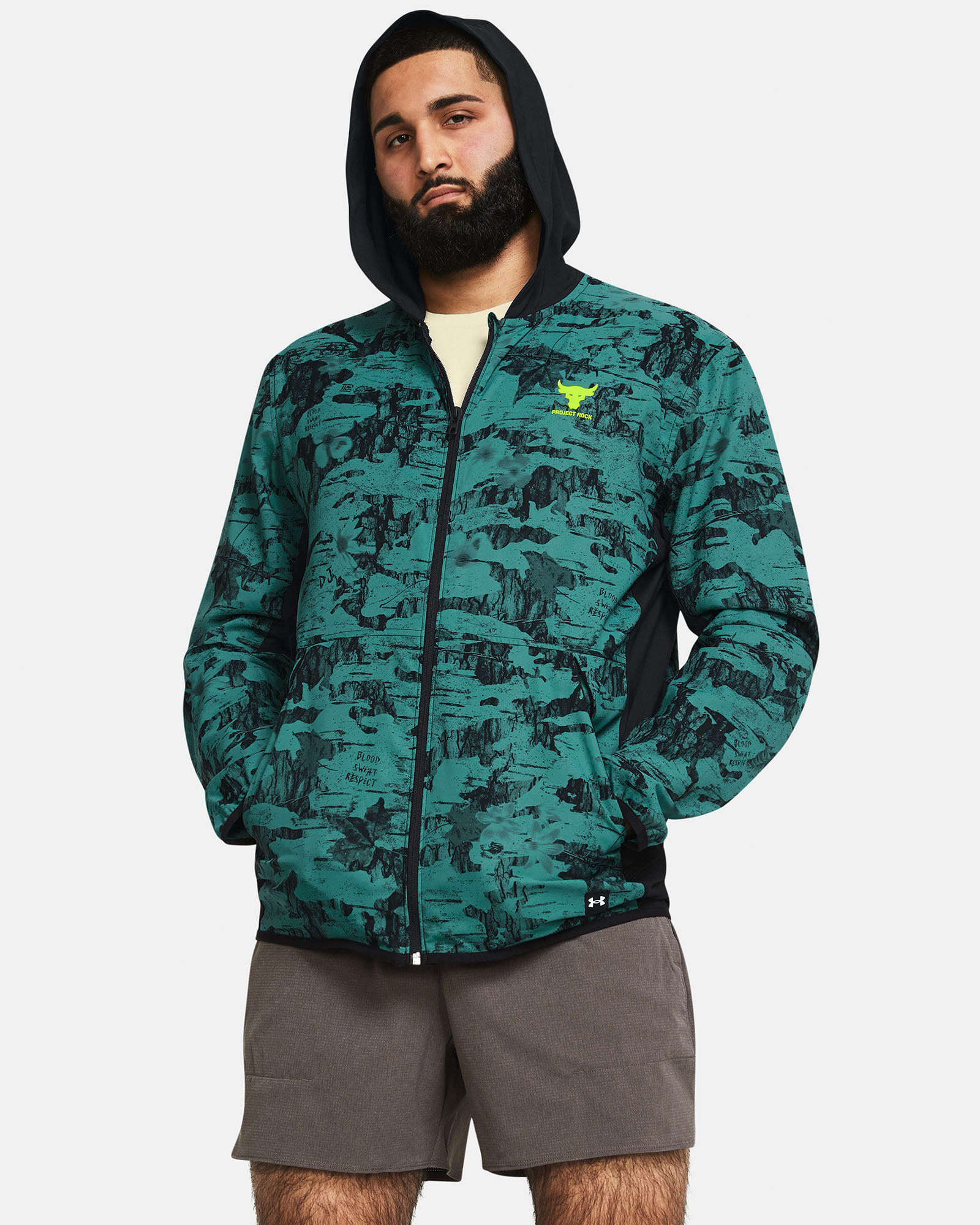 Muhammad Abbasi | Under Armour | Ecom Shoot | Green patterned jacket with black hoodie