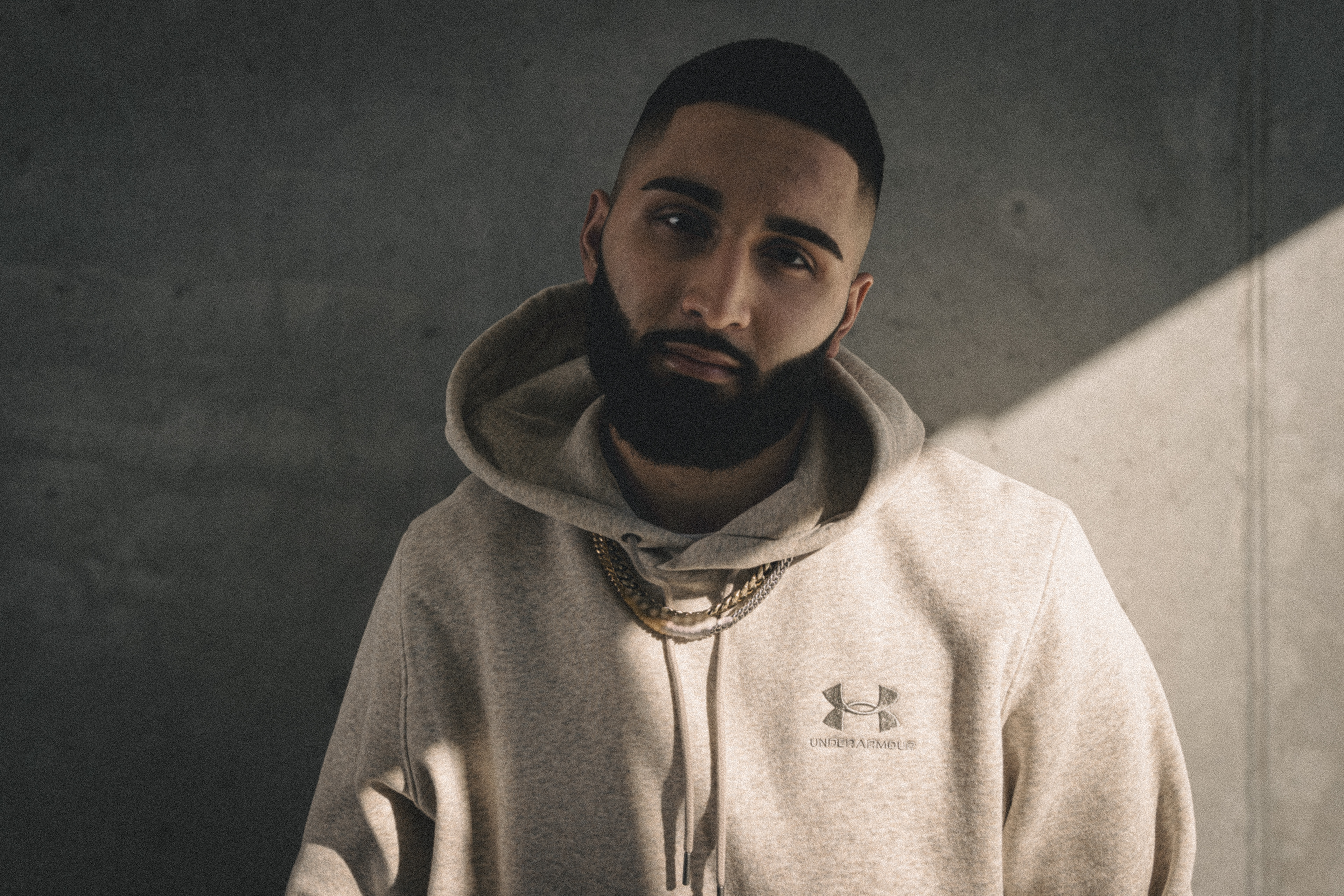 Muhammad Abbasi | Under Armour | ICON Fleece Hoodie | Close-up portrait in soft sunlight