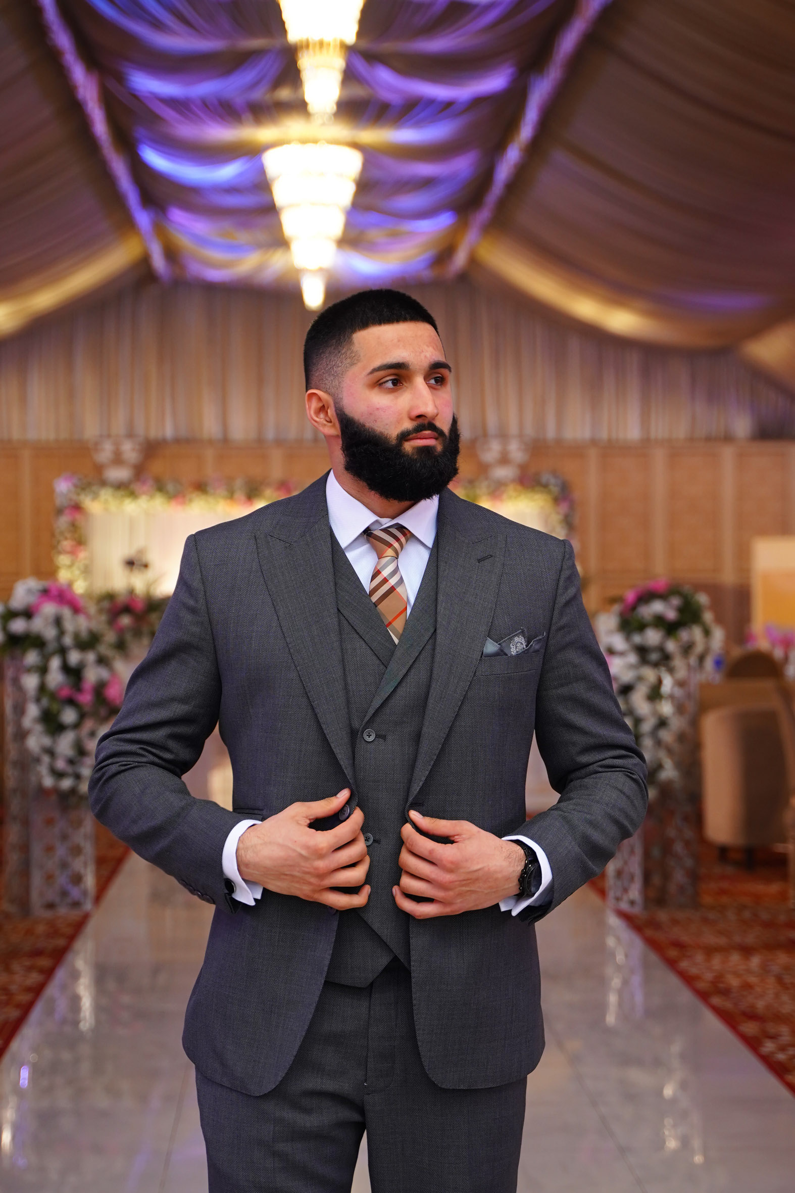 Muhammad Abbasi | Formal Wear | Charcoal three-piece suit with striped tie, adjusting jacket