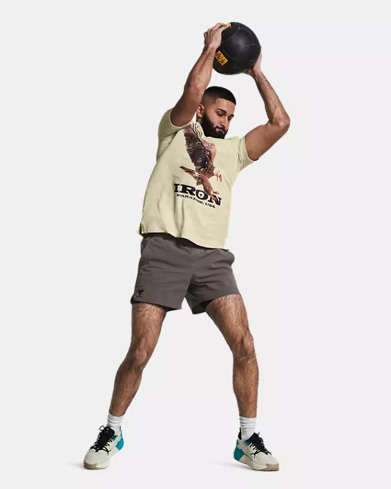 Muhammad Abbasi | Active | Beige graphic t-shirt, gray shorts, lifting medicine ball overhead