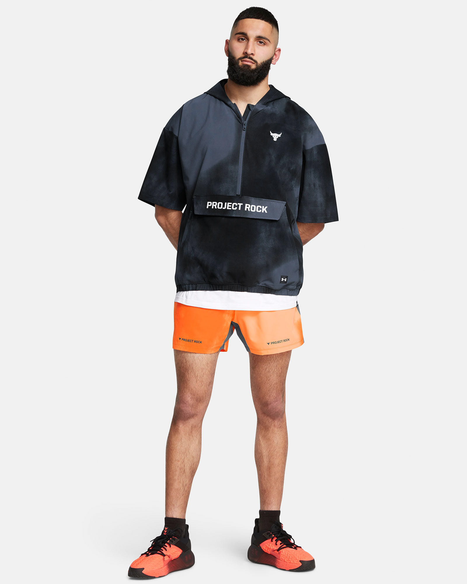Muhammad Abbasi | Under Armour | Ecom Shoot | Project Rock black half-zip top with orange running shorts