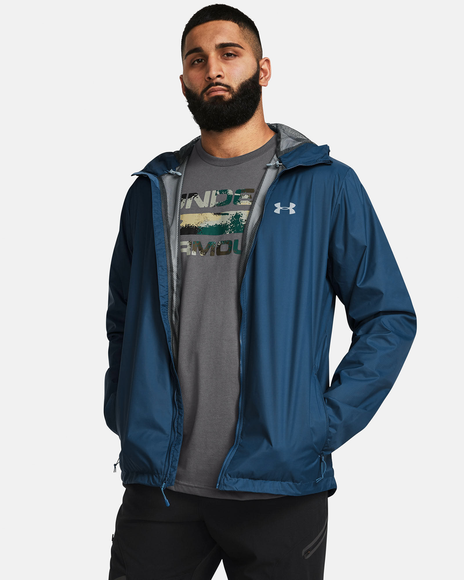 Muhammad Abbasi | Under Armour | Ecom Shoot | Blue zip jacket over grey graphic tee