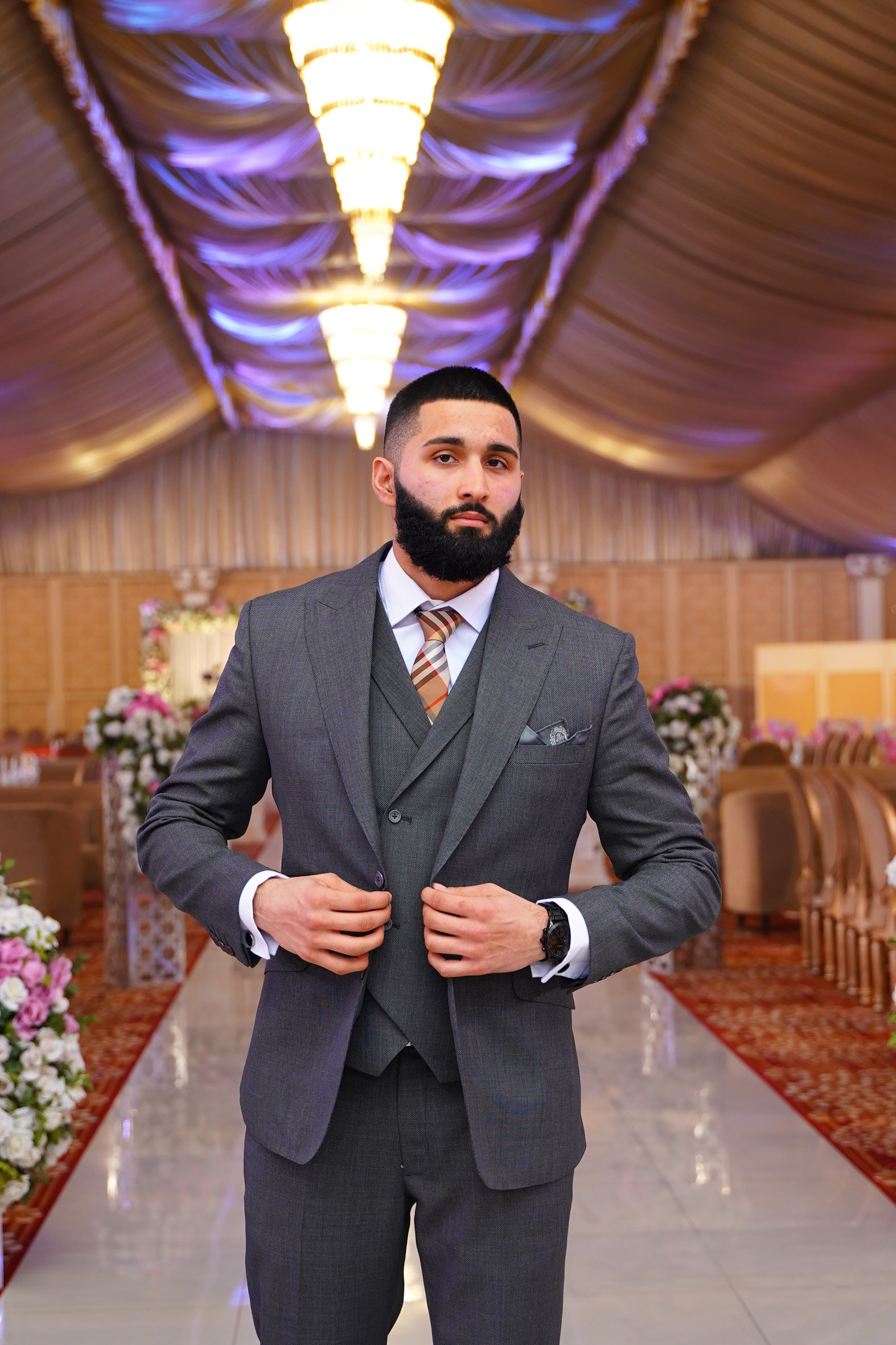 Muhammad Abbasi | Formal Wear | Charcoal three-piece suit with striped tie, adjusting jacket