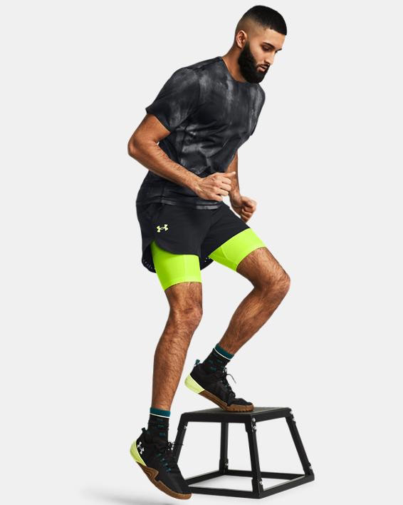 Muhammad Abbasi | Active | Black tie-dye t-shirt, neon green compression shorts, black shorts, mid-step during box drill exercise