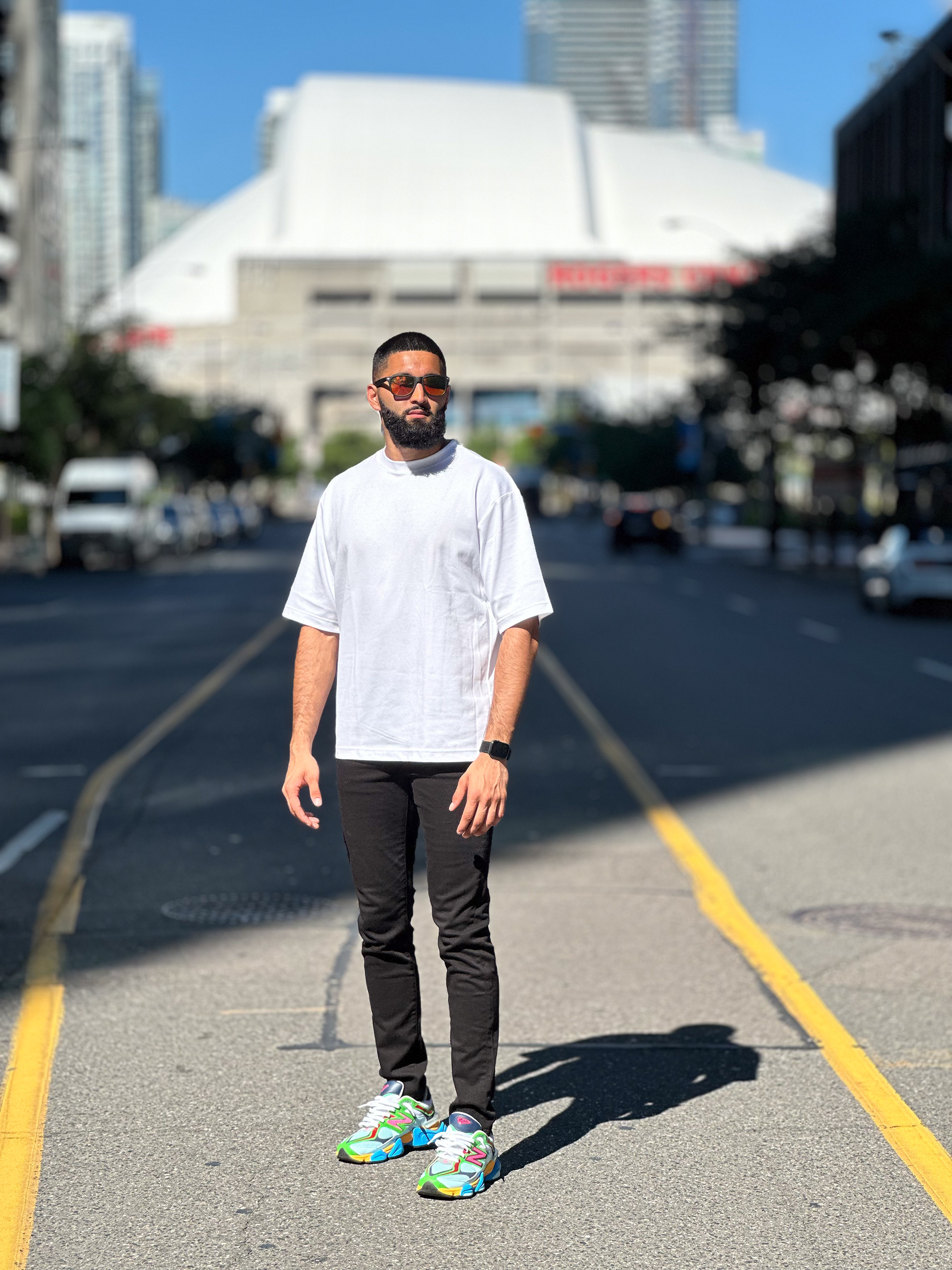 Muhammad Abbasi | Lifestyle | White oversized t-shirt, black jeans, colorful sneakers, close-up street style pose