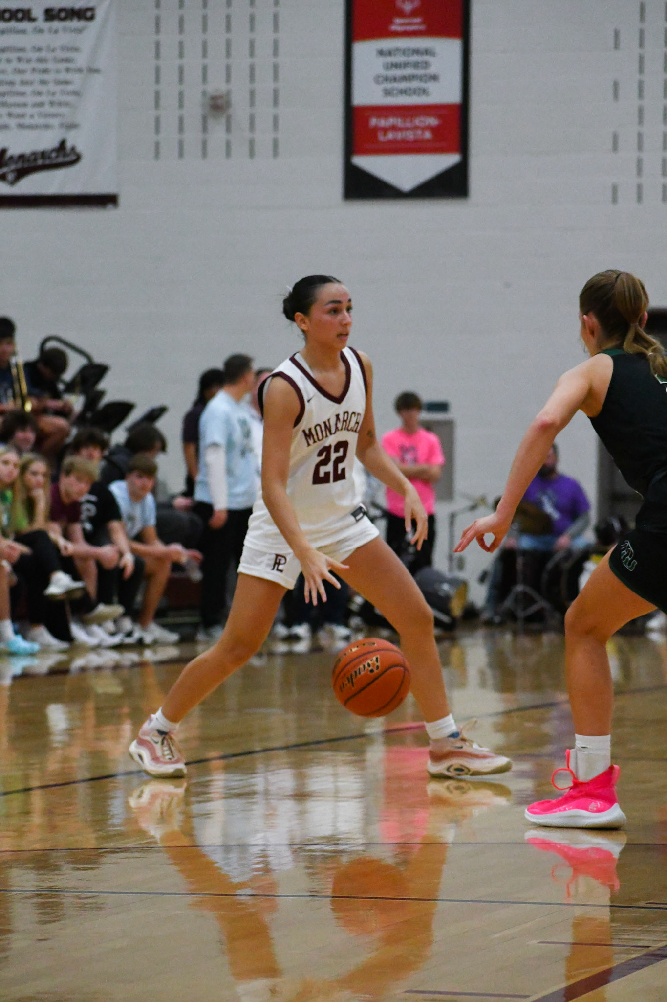 Grace Reyes dribbles the ball cross court against a Millard West defender.
