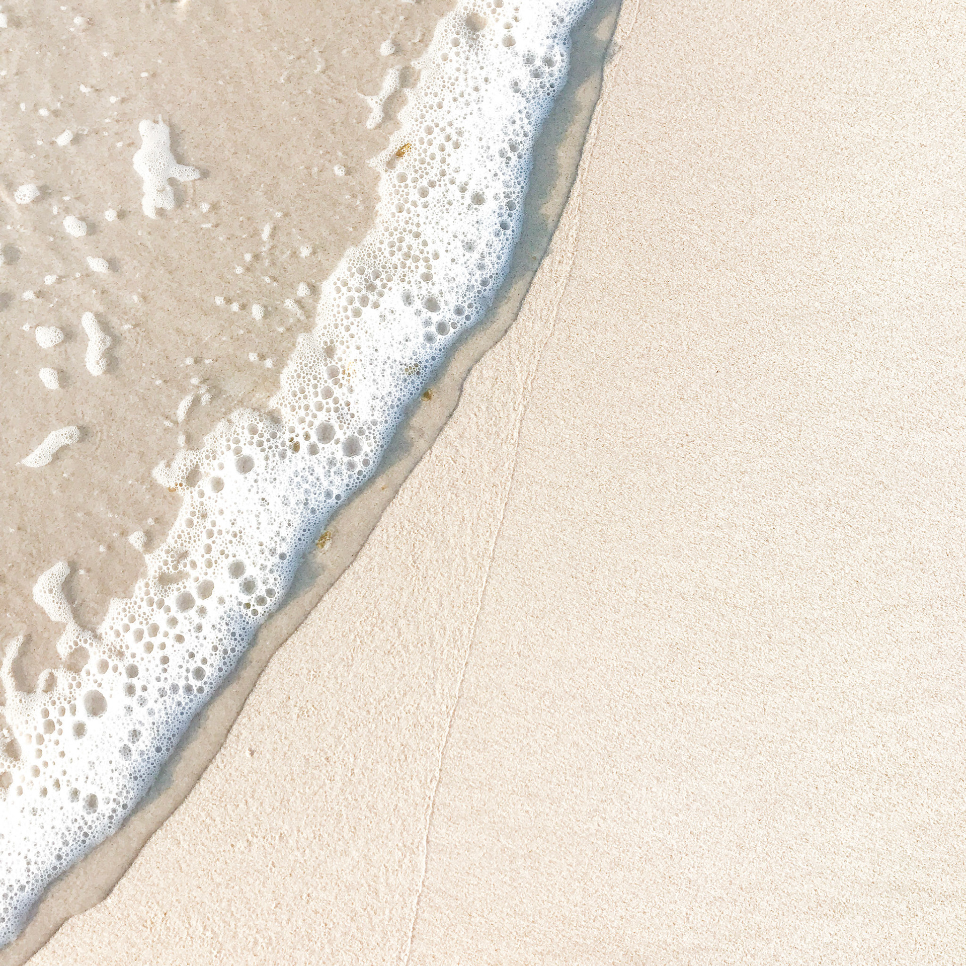 Warm White Beach Sand Background with Wave on left side