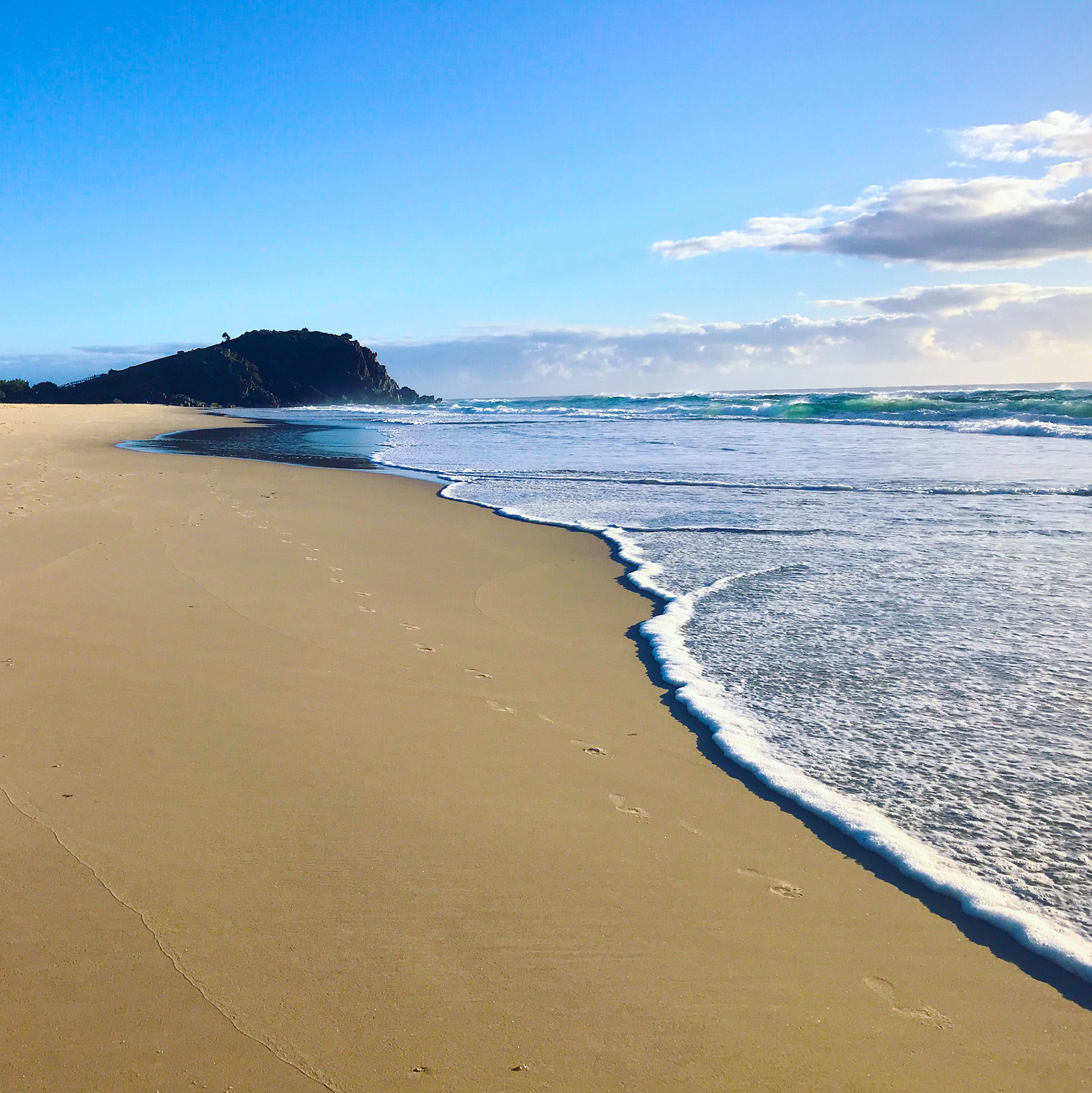 Footprints in the sand at sunrise Cabarita Beach