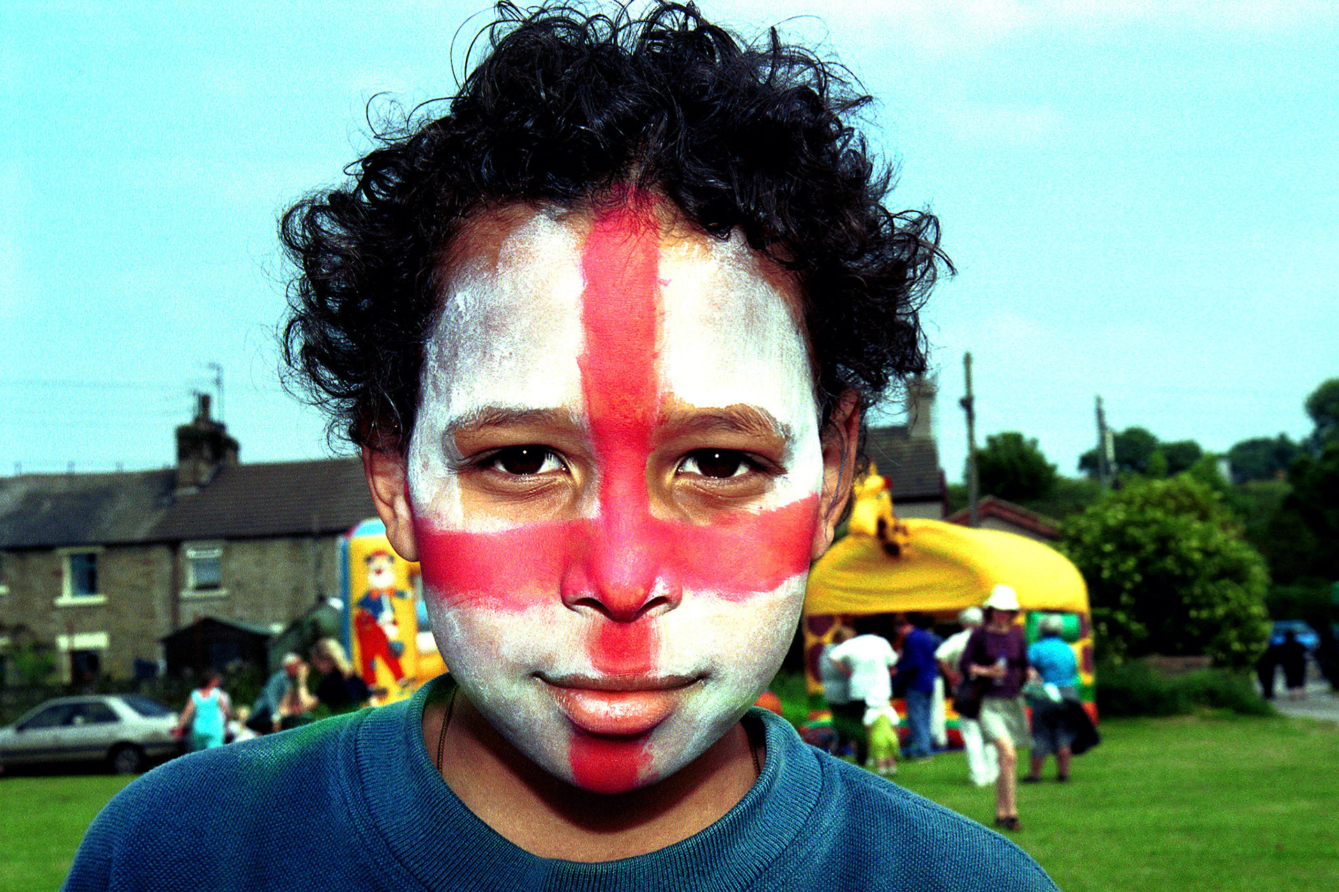 David Fusco paints his face in anticipation of the later football game between England and Germany (Euro 2000), Lancashire, UK June 2000