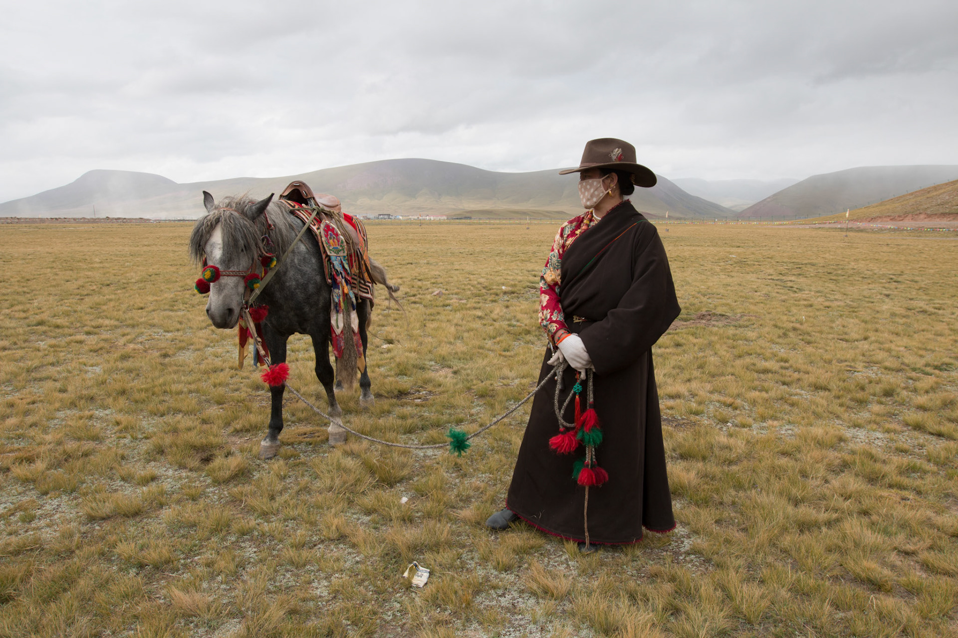 Horsemen prepare for a local race in Quamalai. Ground temperatures have slowly risen in Qumalai county so a permanent frozen layer of soil just beneath the ground has melted away. The permafrost had acted to hold water near the surface allowing the grasslands to thrive but without it, the rain drains away leaving no water for the grass to feed on. The area is home to the sources of three of Asia’s great rivers, the Yangzi, the Yellow and the Mekong. Any ecological catastrophe here would affect hundreds of communities downstream. 05/09/2013, Qumalai, China.