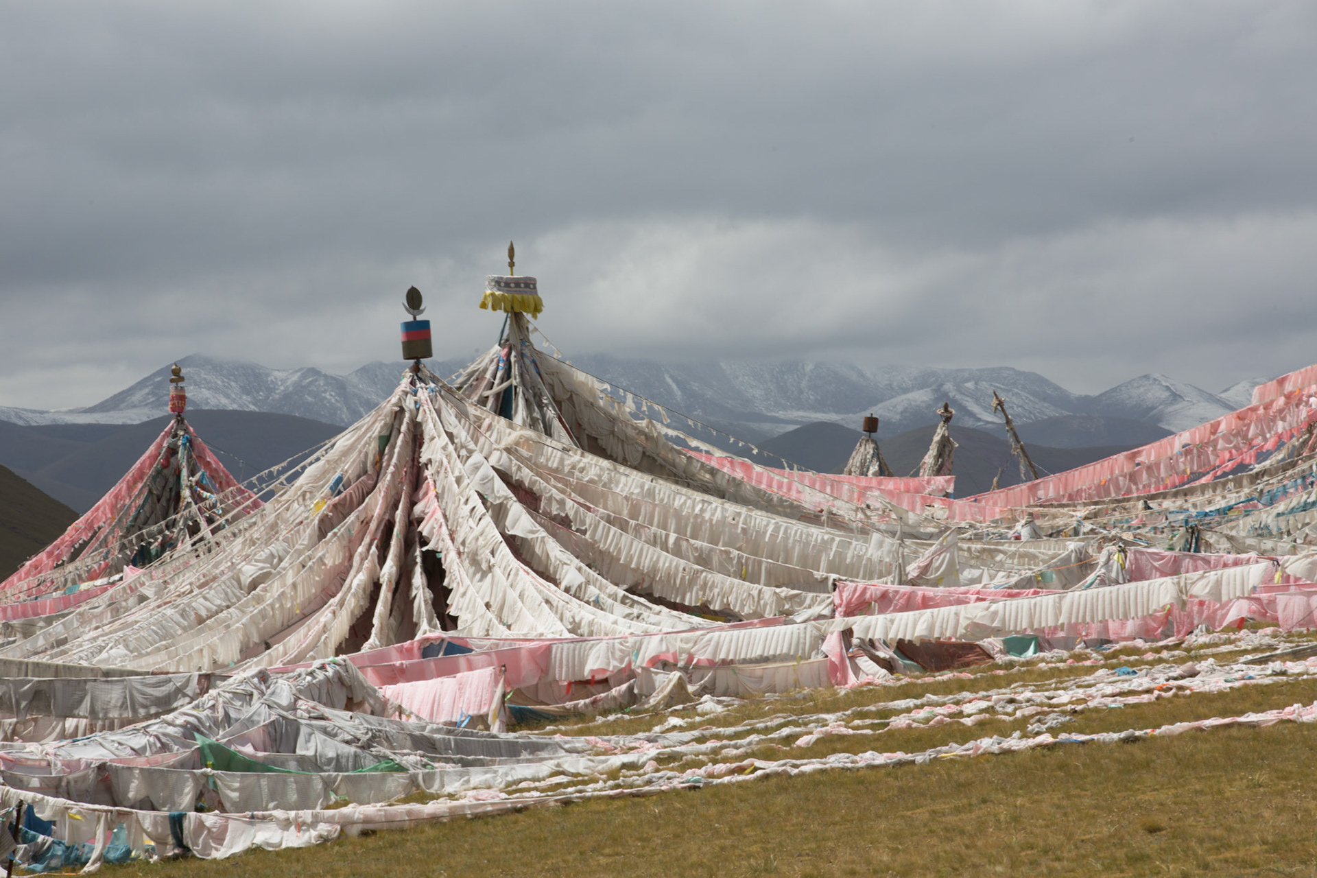 Prayer flags on the hill above Qumalai.Ground temperatures have slowly risen in Qumalai county so a permanent frozen layer of soil just beneath the ground has melted away. The permafrost had acted to hold water near the surface allowing the grasslands to thrive but without it, the rain drains away leaving no water for the grass to feed on. The area is home to the sources of three of Asia’s great rivers, the Yangzi, the Yellow and the Mekong. Any ecological catastrophe here would affect hundreds of communities downstream. 05/09/2013, Qumalai, China.