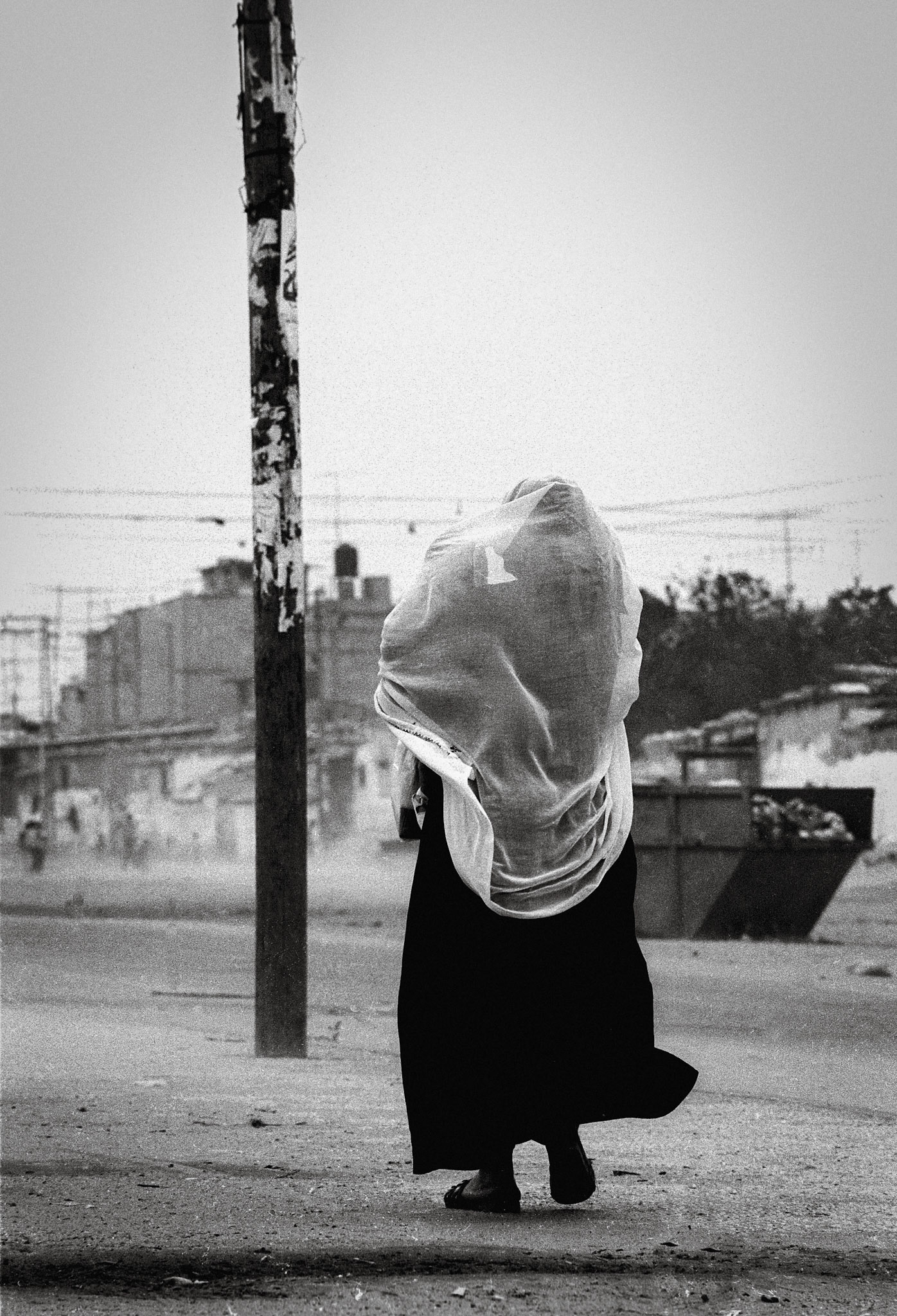 As an Israeli patrol enters the camp so women and children run for cover and young men arm themselves with rocks to throw. In 1991 D J Clark was commissioned by The Guardian Weekend Magazine to document life in the last remaining Palestinian stronghold. A small corner of the Rafah refugee camp in the Gaza strip known to its residents as Shabora. Over the past ten years Clark has returned to this community on a regular basis to document the changes in lifestyle as the people that live there cope with the ups and downs of living in one of the most troubled areas of the world.