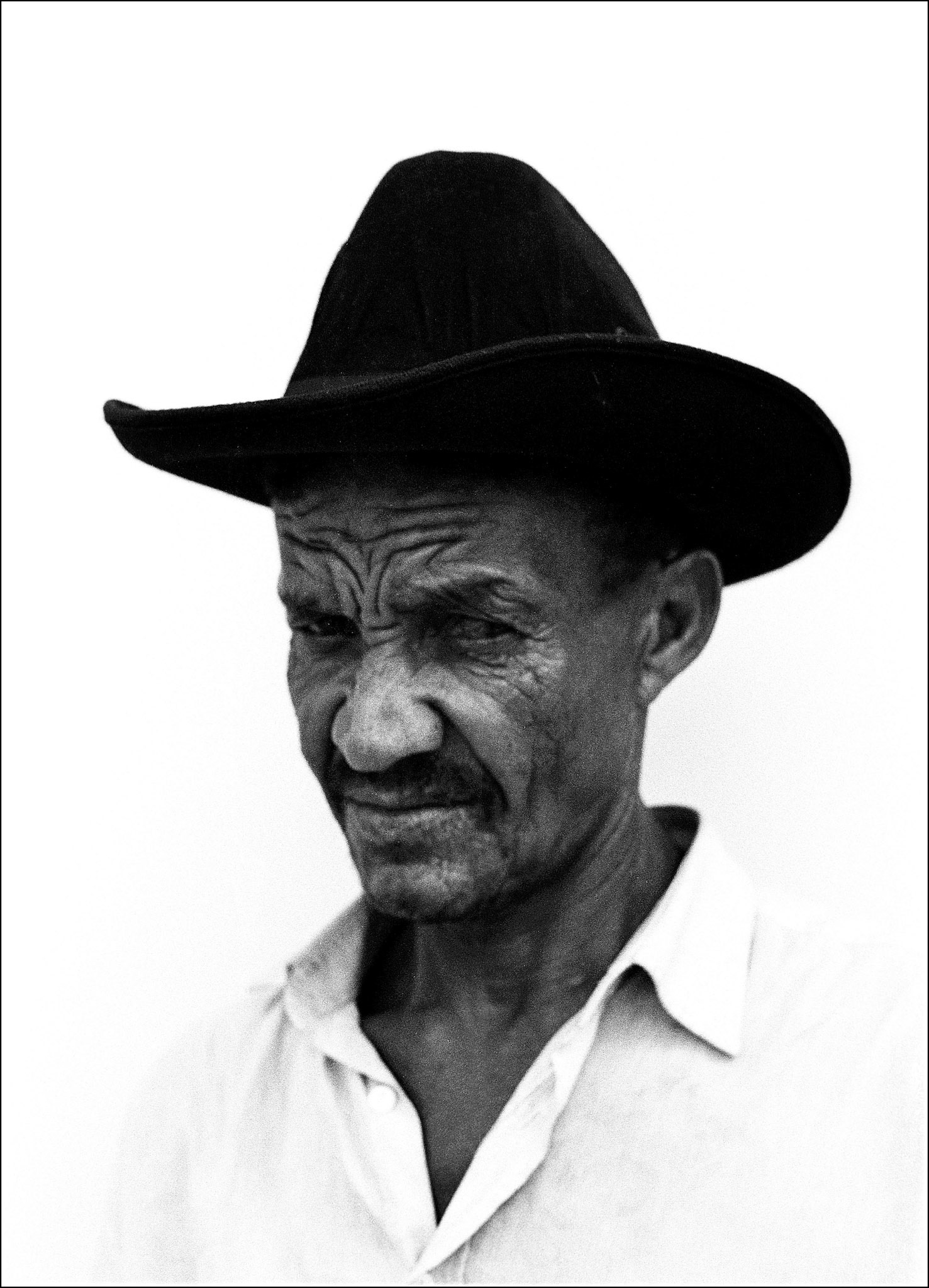 A cowboy looks into the camera. Galinhos is a small oceanside village in the far north of Brazil. Poised on a thin peninsular it can only be reached by a small fishing boat or by walking over the sand dunes that guard it from the mainland. The people make their living from the sea that surrounds them, and the few tourists that dare to venture. The village is however far from sleepy. After the boats come in the music is turned up, and the party starts, everyone loves to dance.  North West Brazil, August 1999