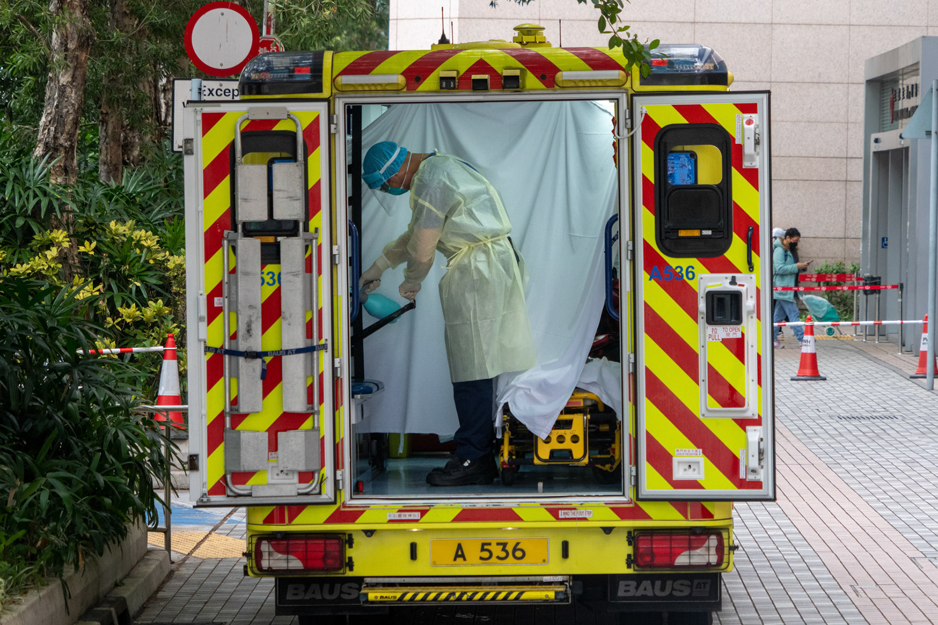 People, including hospital patients showing COVID-19 symptoms, wait at a temporary holding area outside Caritas Medical Centre.18/2/2022, Kowloon, Hong Kong, China.