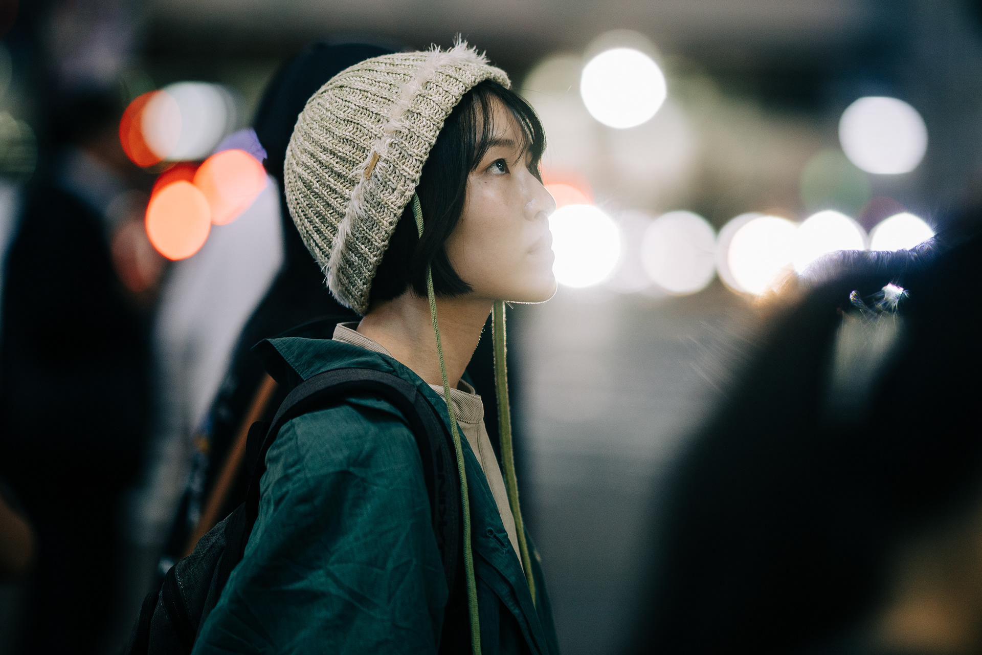 Candid night portrait in Shibuya crossing with cinematic bokeh and soft light diffusion, professional portrait photography by Actually Photos.