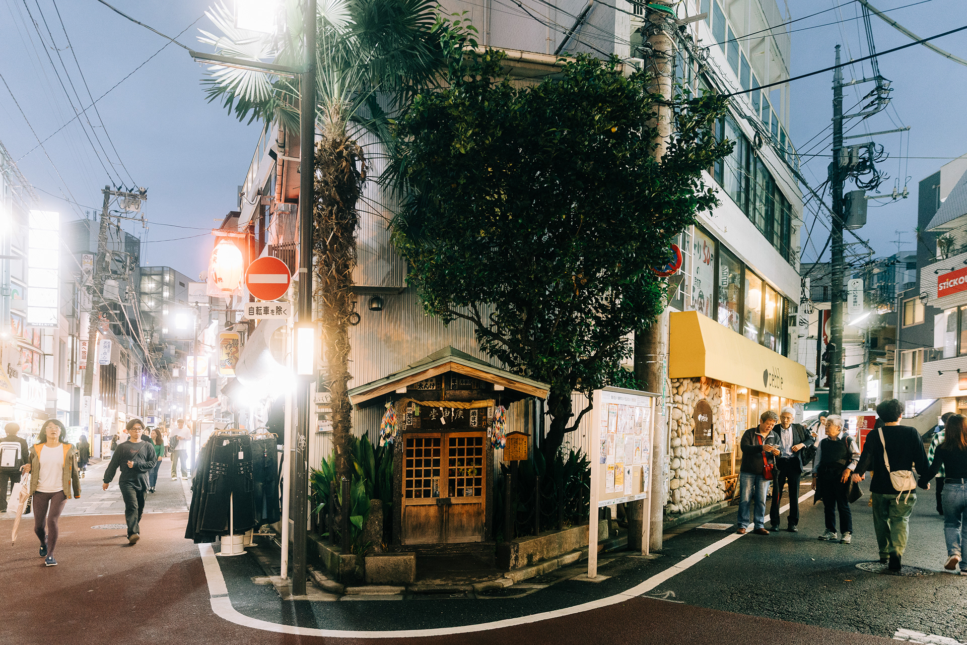 Atmospheric night street photography of a traditional Japanese shrine in a Tokyo alleyway, filmic light and shadow by Actually Photos