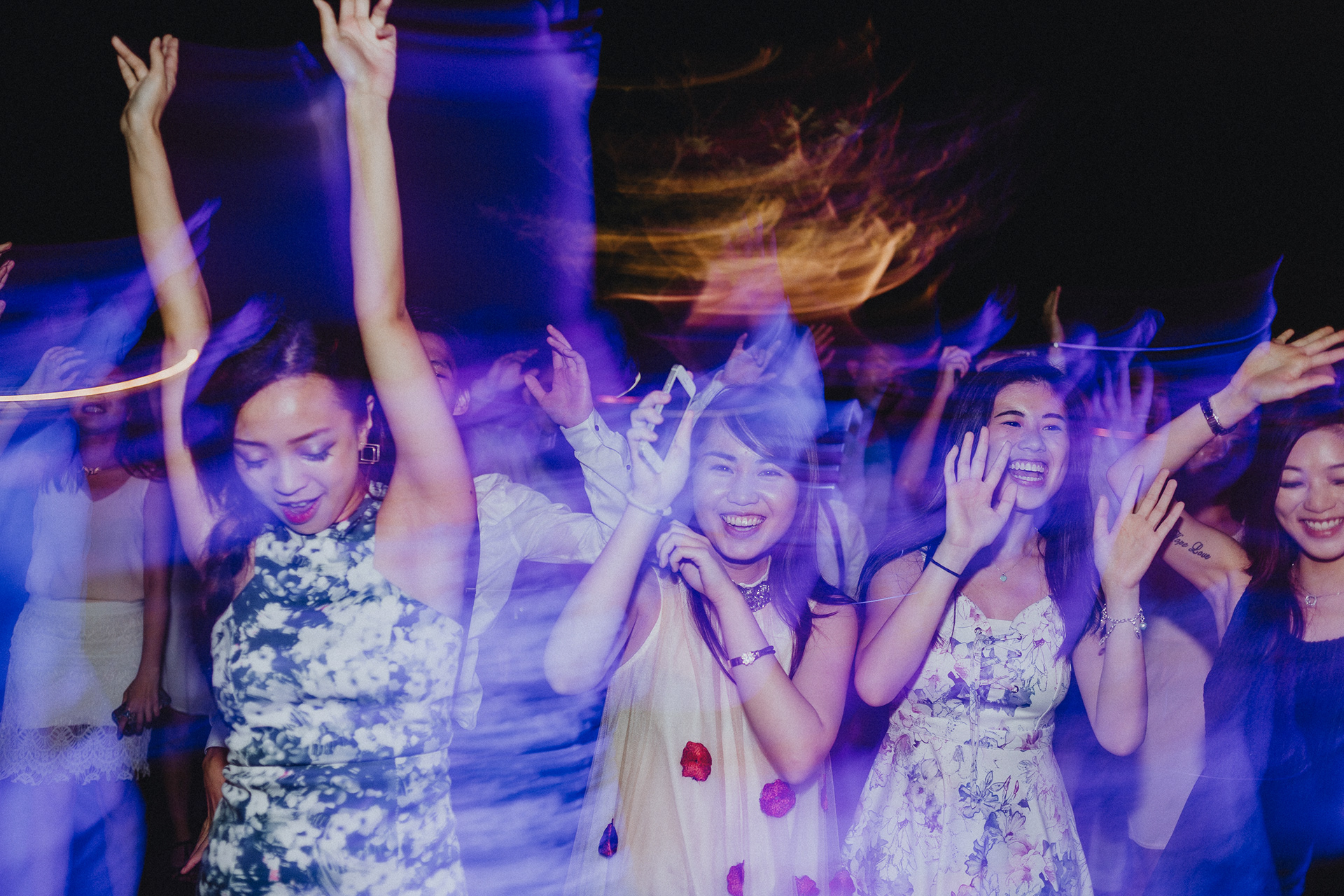 Cinematic unit-still capturing the blurred kinetic energy and high-velocity motion of an urban celebration; high-fidelity documentation of crowd euphoria with vivid neon luminescence and rhythmic lighting trails.