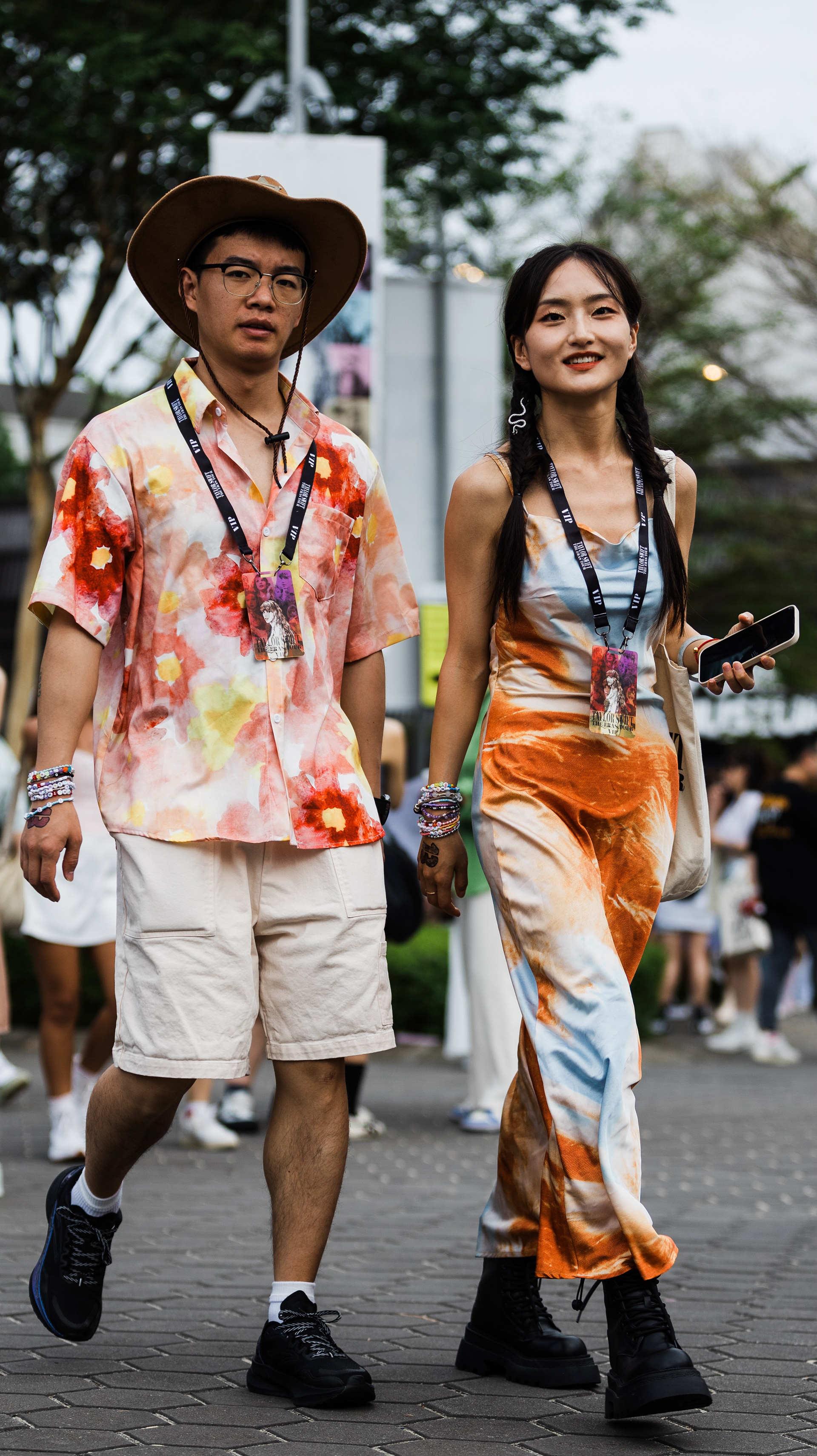 Extraction of the 'Red' era persona. Two participants in high-contrast patterned outfits, capturing the vibrant energy and artisanal dedication of the subculture. A key frame of movement and cultural identity.
