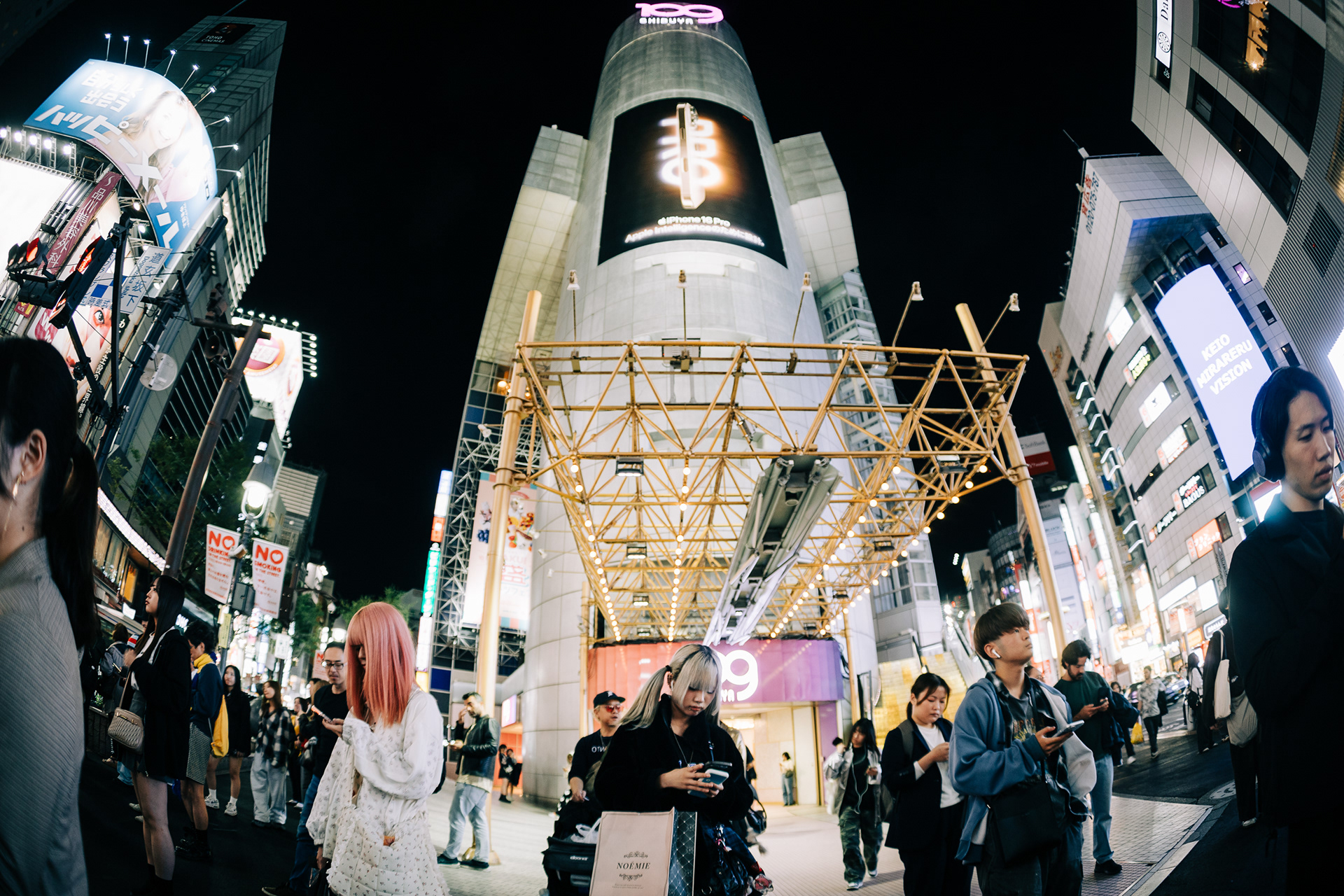 Ultra-wide night street photography of Shibuya 109 building and crowds, cinematic urban atmosphere, Actually Photos Singapore destination photographer