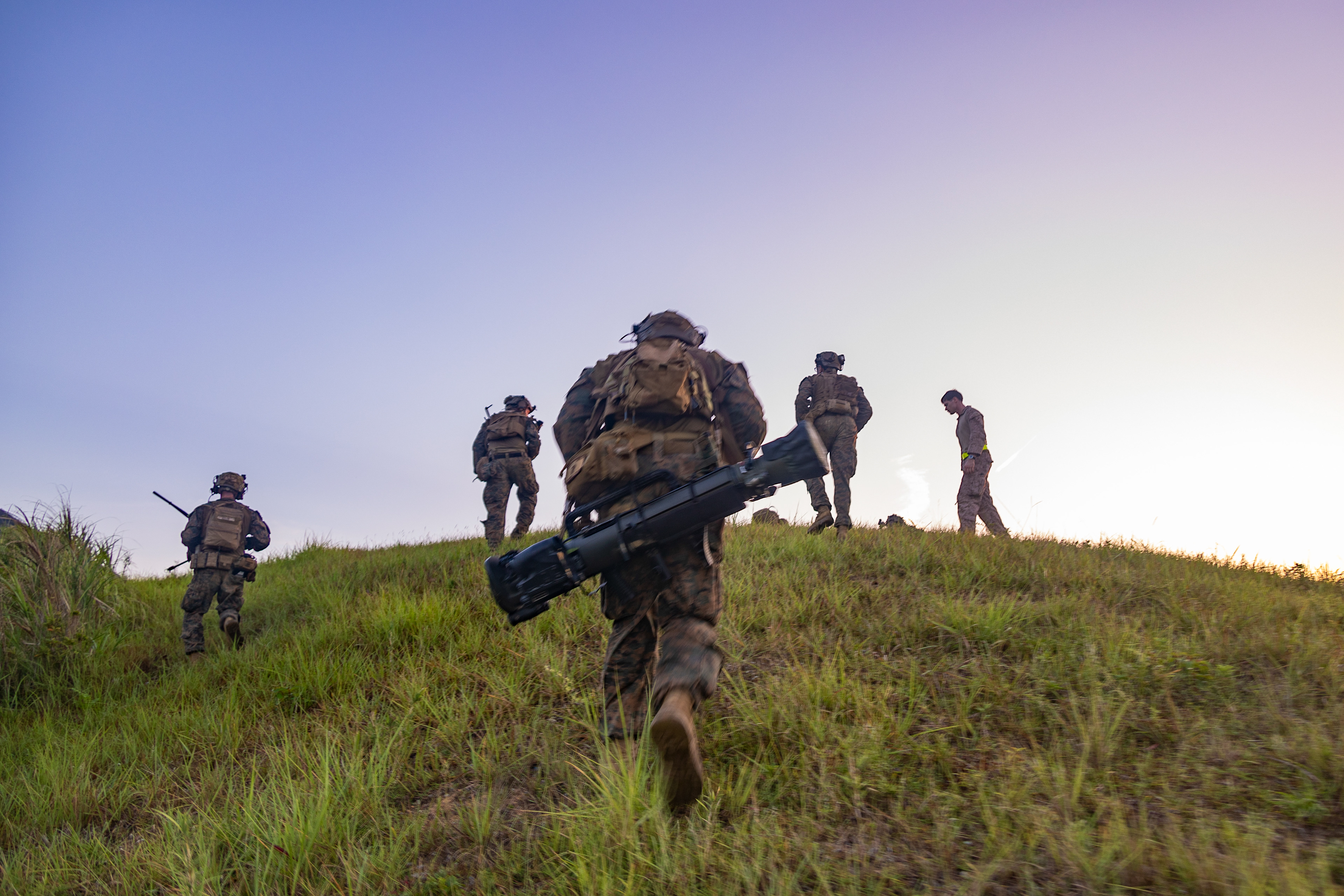 U.S. Marines with Battalion Landing Team 1/4, 31st Marine Expeditionary Unit, advance their position during a mechanized raid exercise at Camp Schwab on Aug. 13, 2024 in Okinawa, Japan.