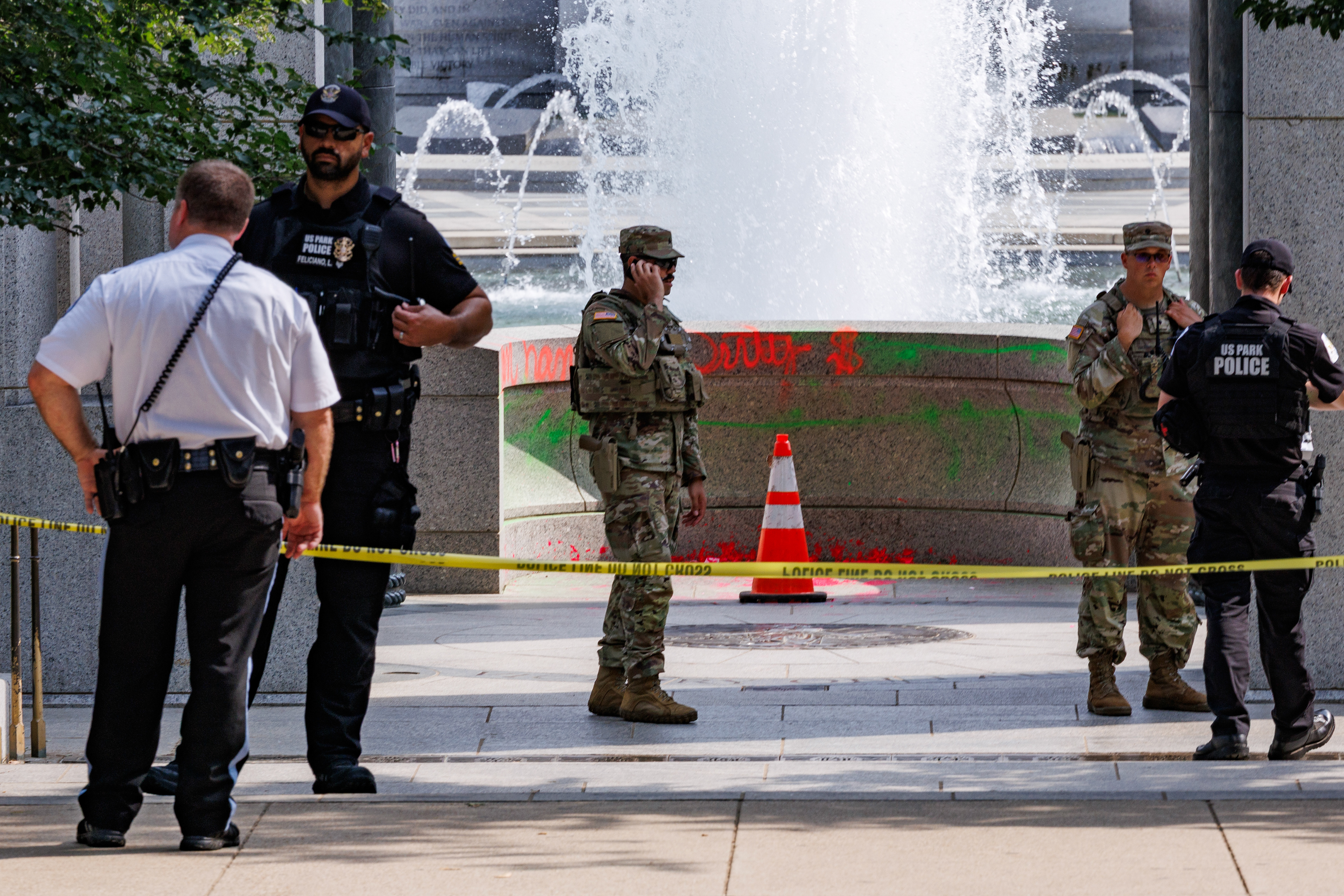 Authorities stand near the World War II Memorial following a vandalism incident on August 13, 2026 in Washington DC. (Photo by Tyler M. Andrews/The Washington Post)