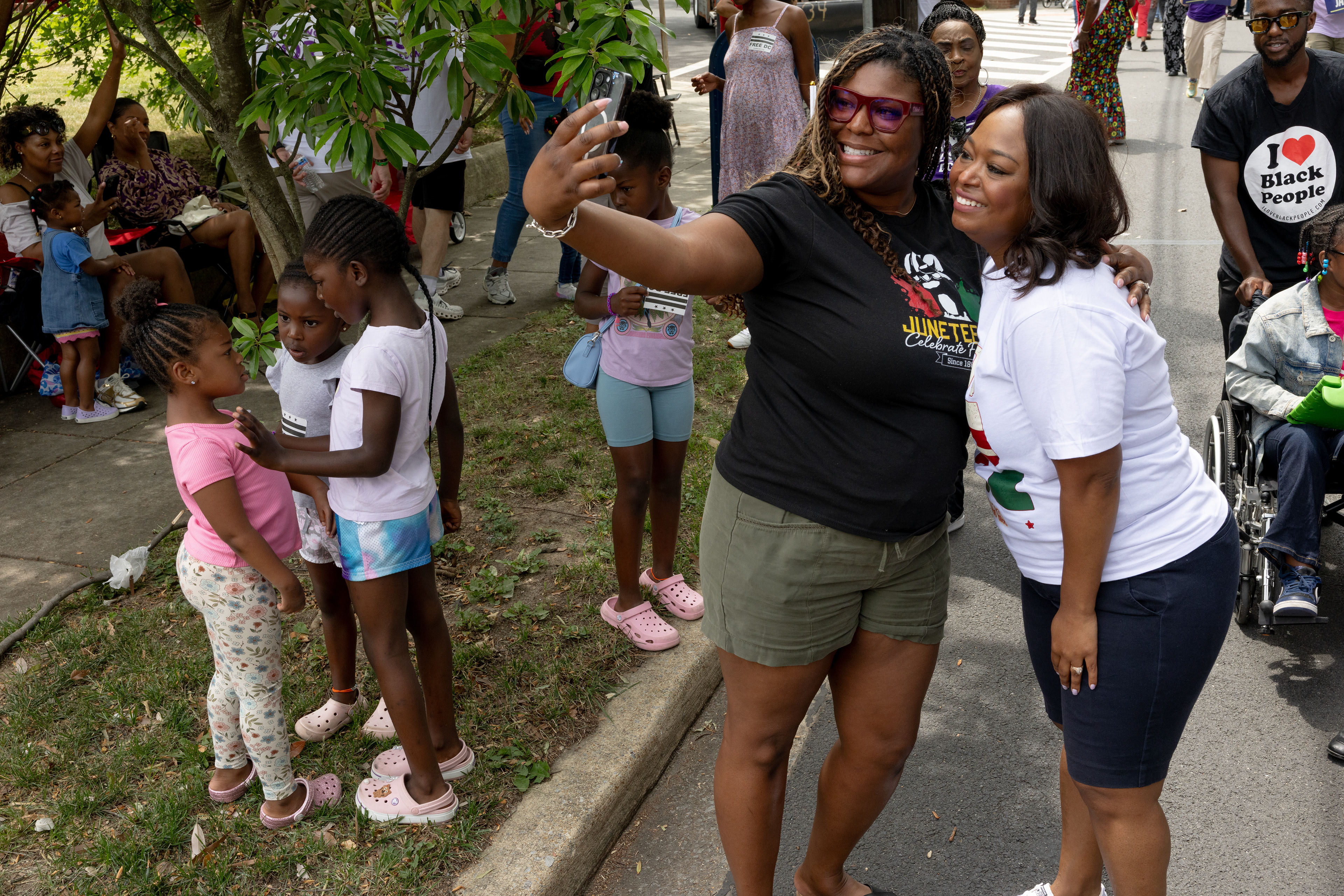 Ward 4 Council member Janeese Lewis George poses for a selfie with a community member during the Ward 7 Juneteenth Parade on Branch Ave Southeast on June 19, 2026 in Washington, D.C. (Photo by Tyler M. Andrews/The Washington Post)